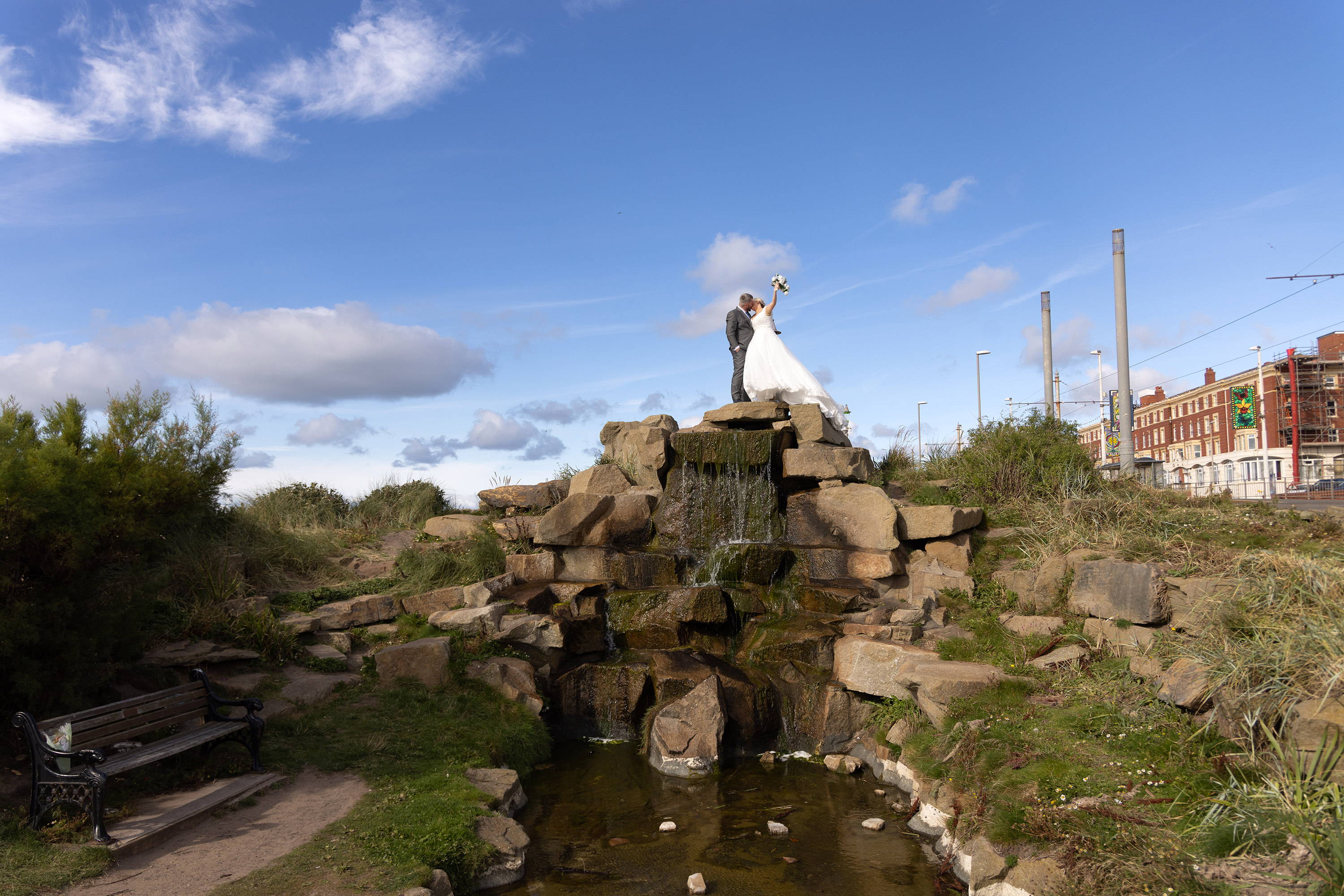 Gavin and Katie celebrate their wedding with a kiss on top of the waterfall in Blackpool