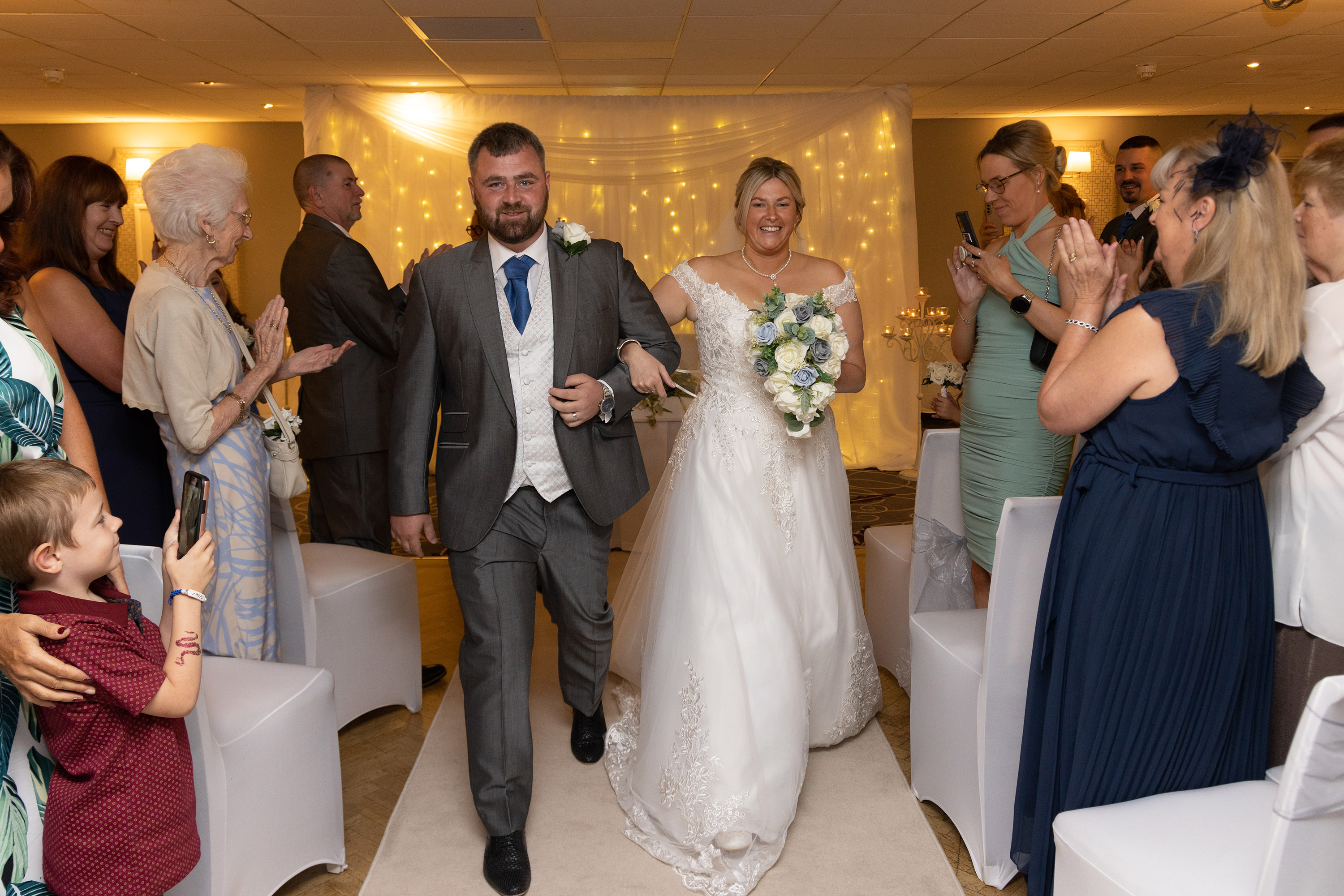 The bride and groom walk down the aisle at the Sheraton Hotel wedding