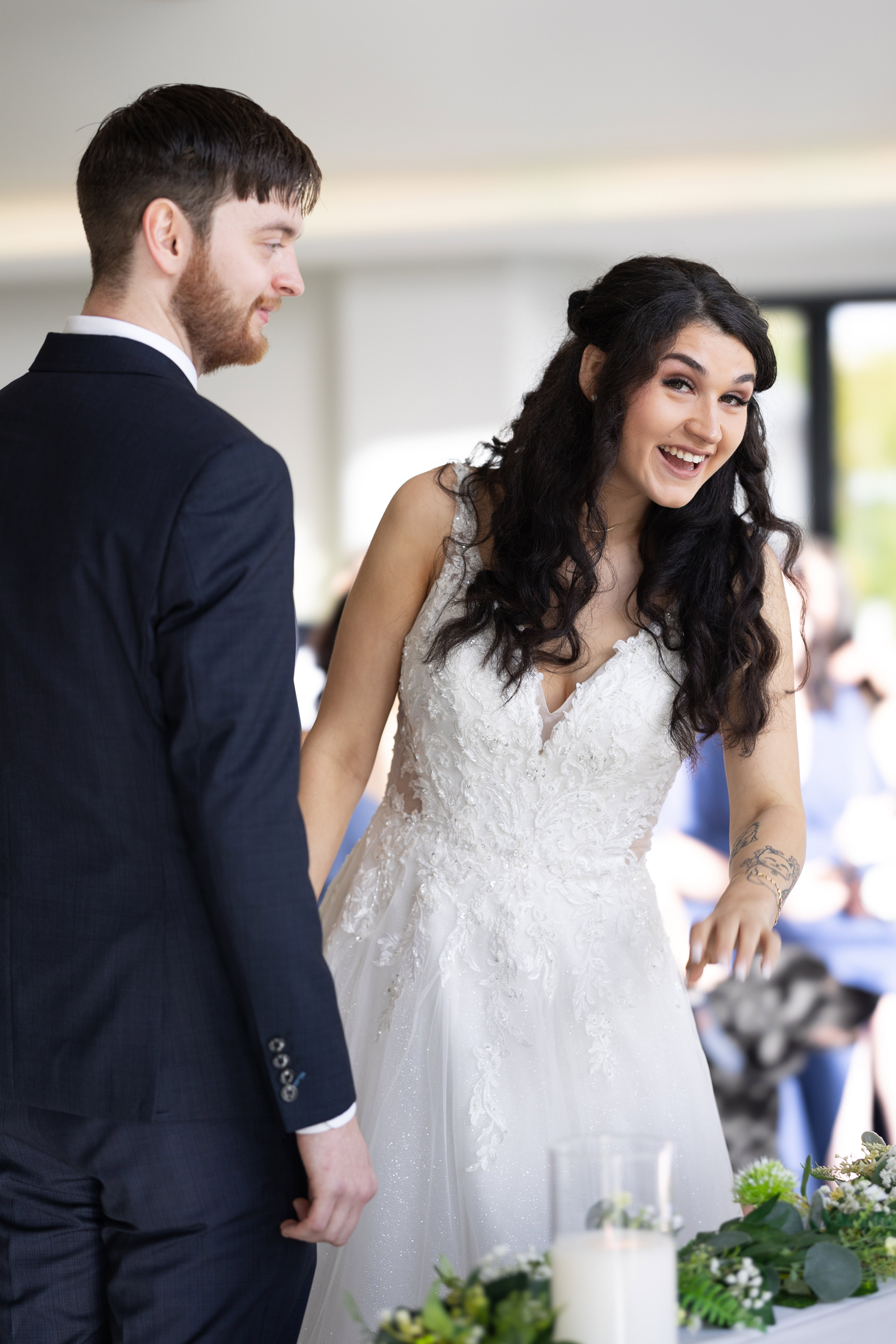 Emily and Neil laughing at the wedding 