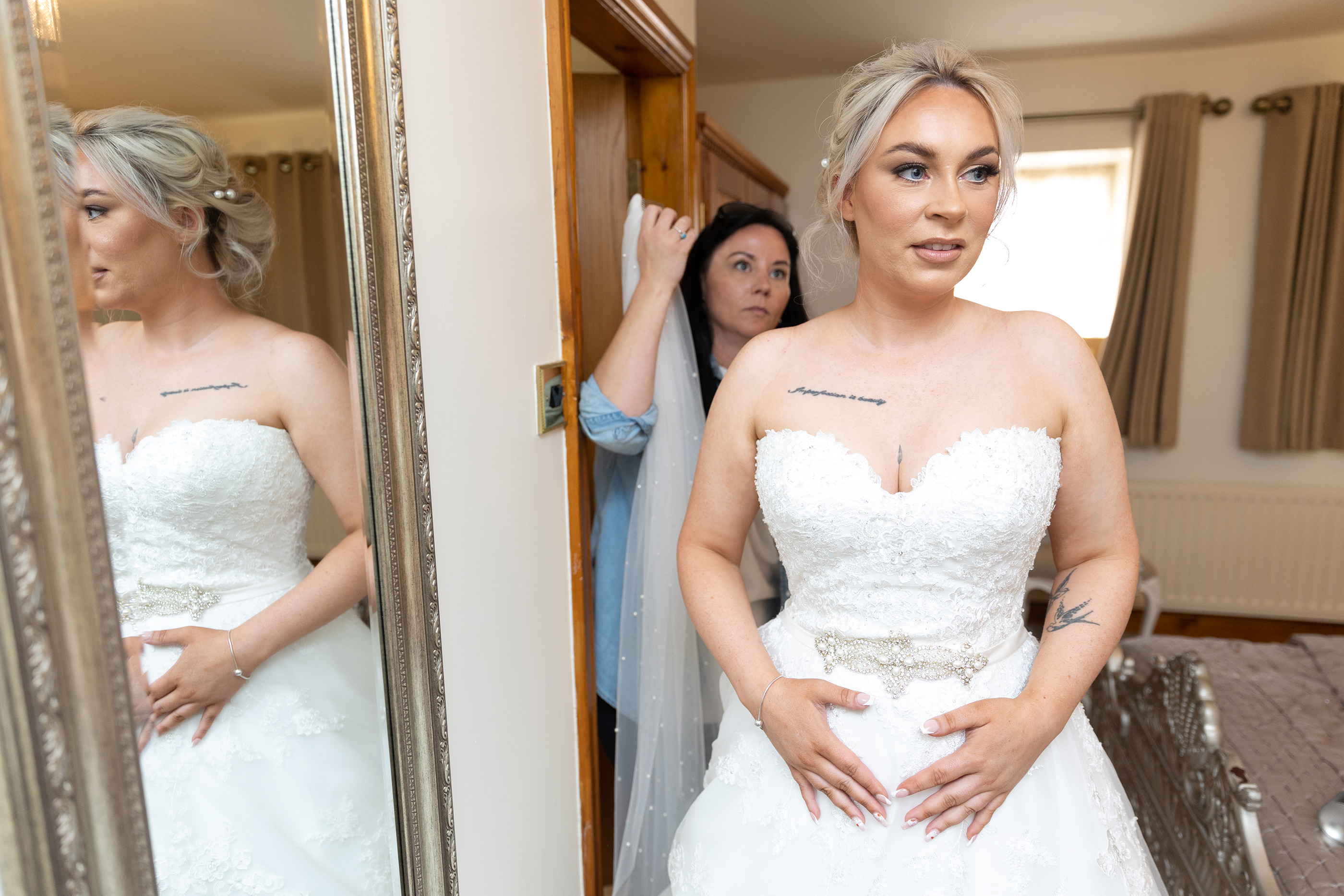 The Bride putting on her wedding Veil
