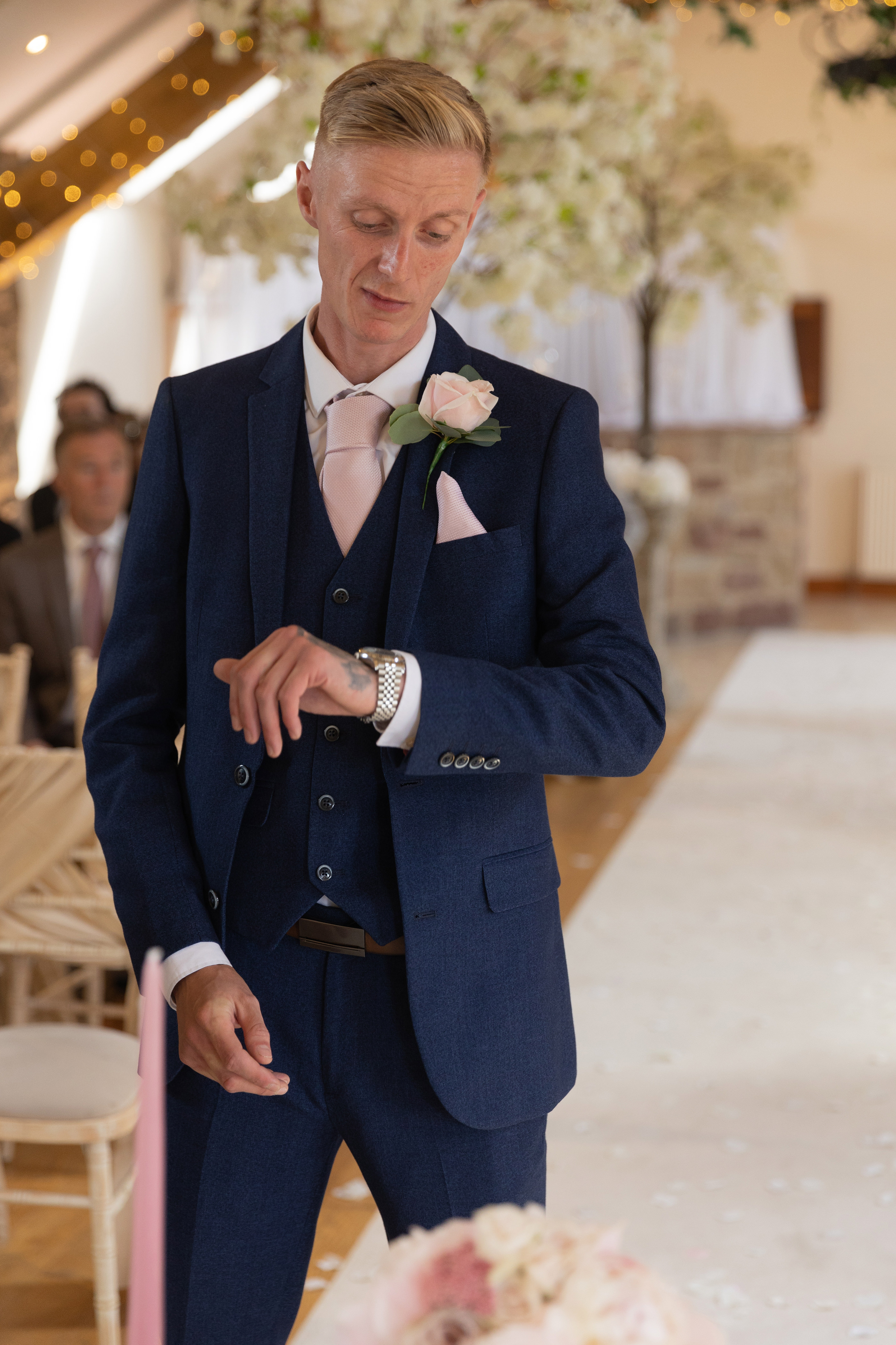The groom Joshua looking at his watch