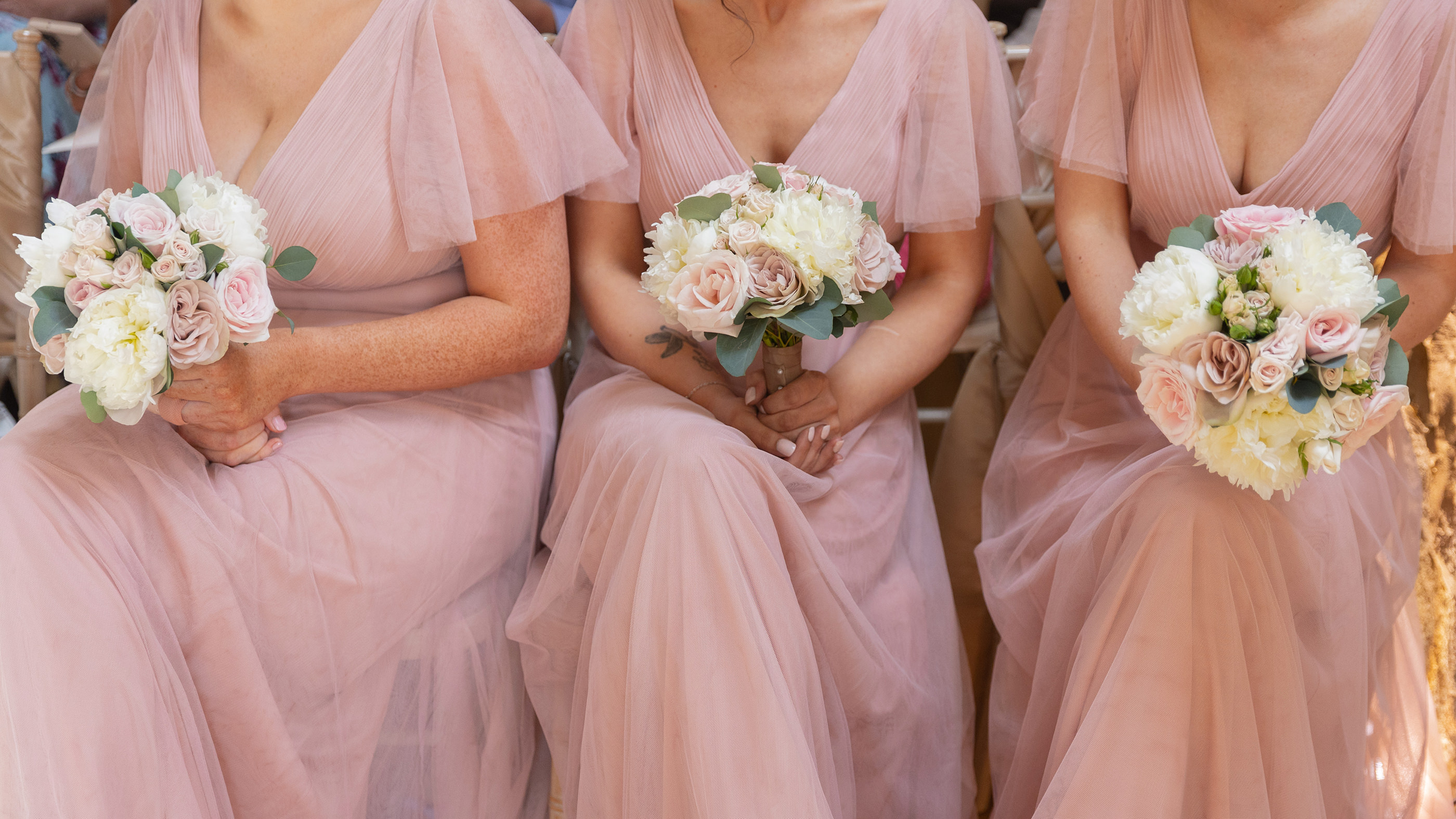 The bridesmaids holding their bouquets 