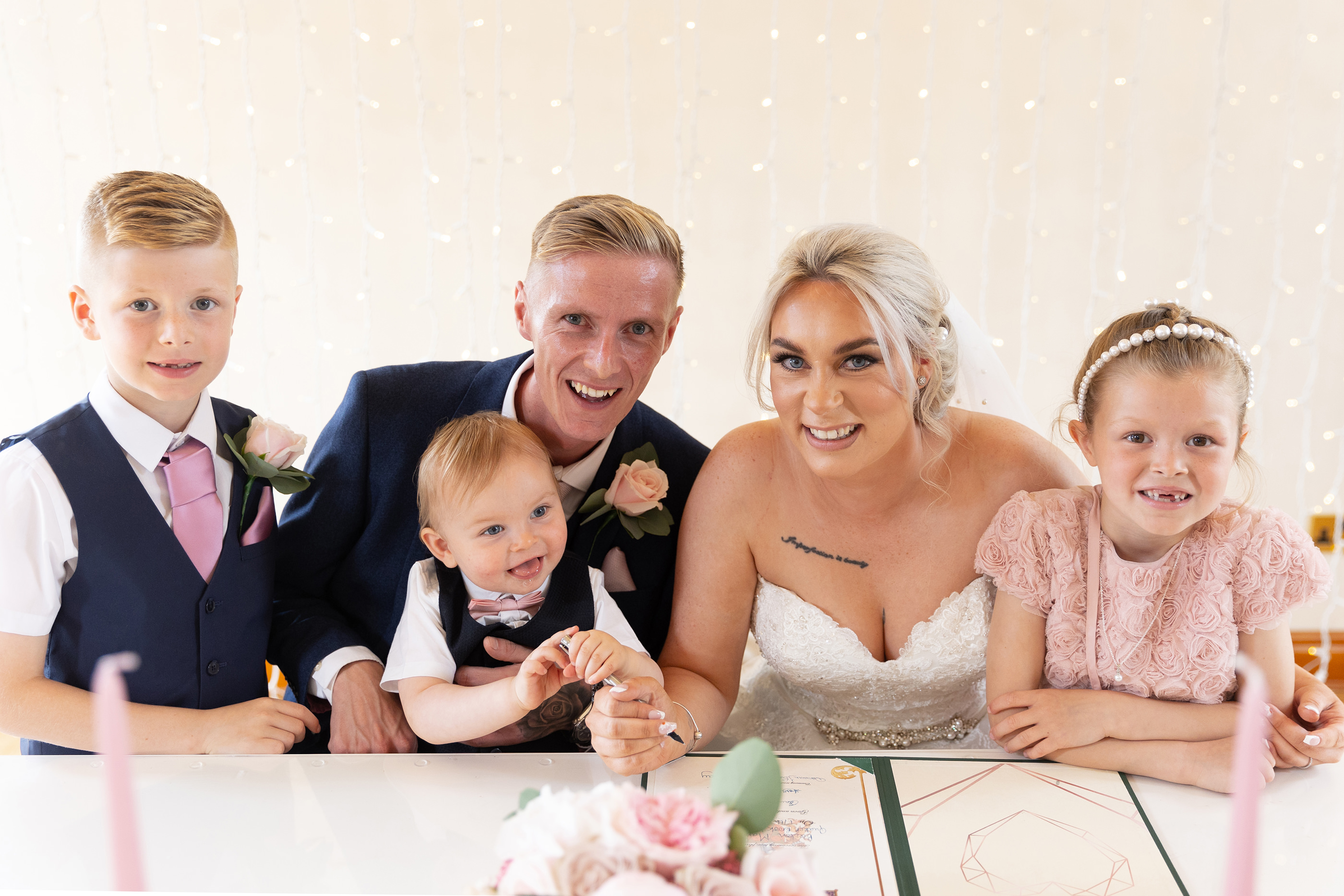 Family photo of the bride and groom and their children