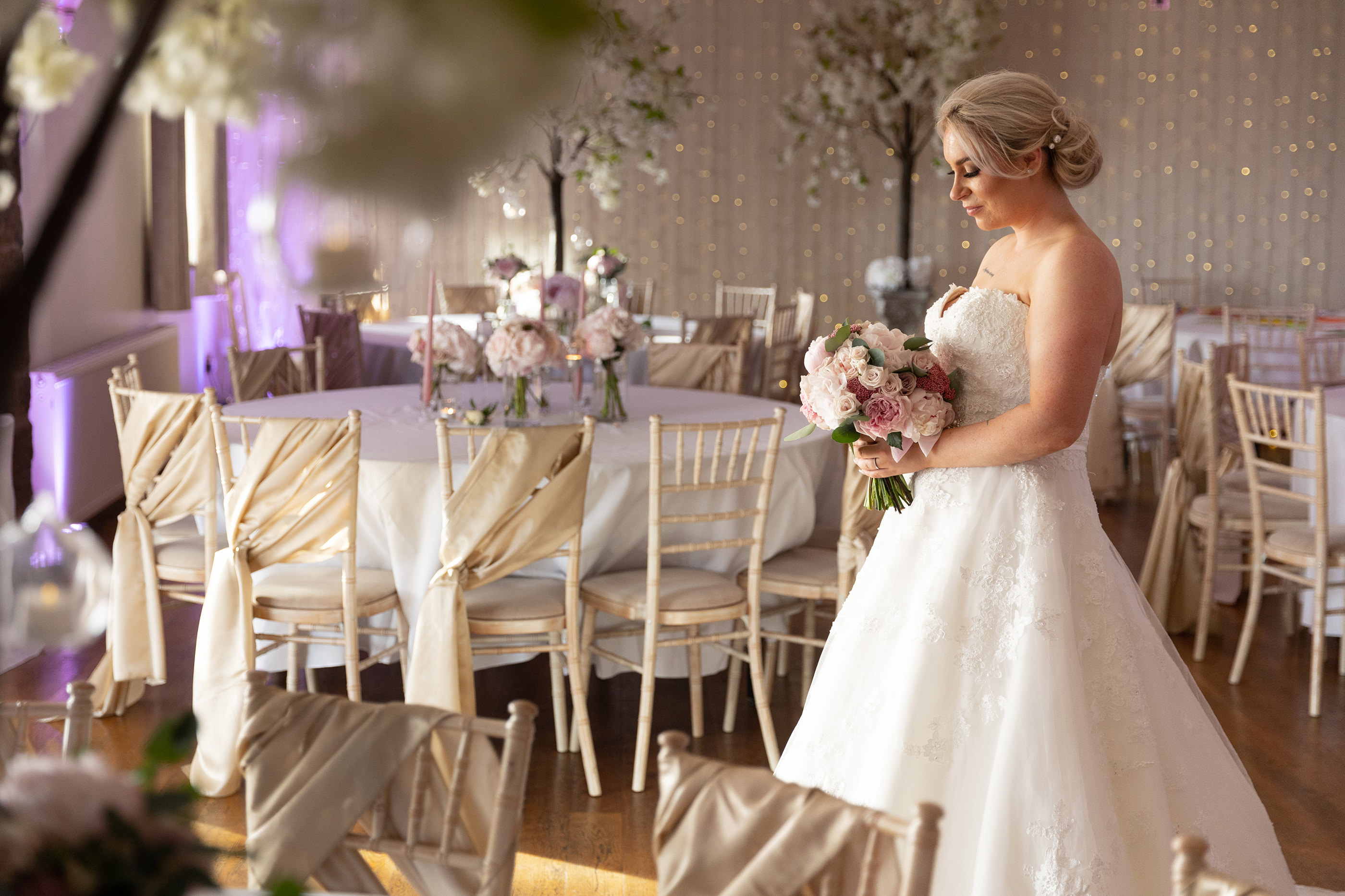 The Bride standing in the wedding reception room