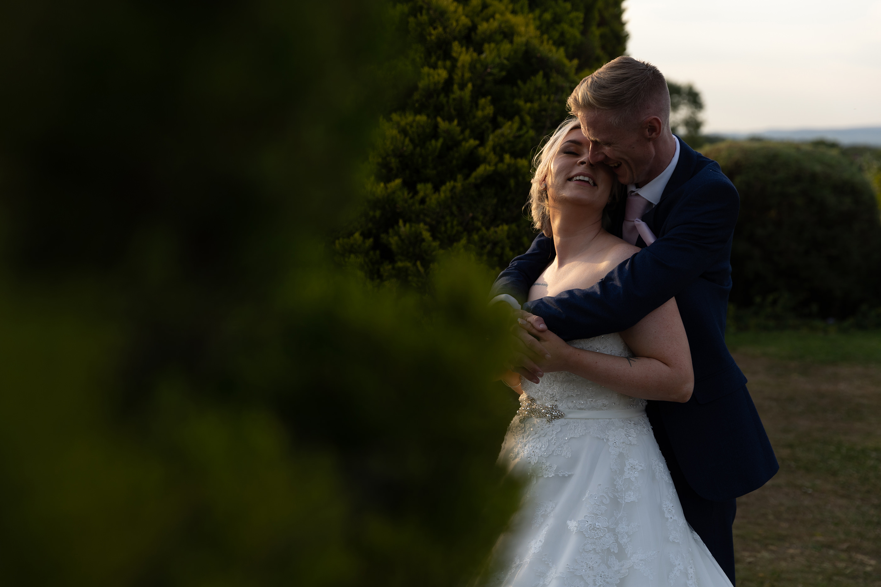 The bride and groom have some evening sunset wedding photos