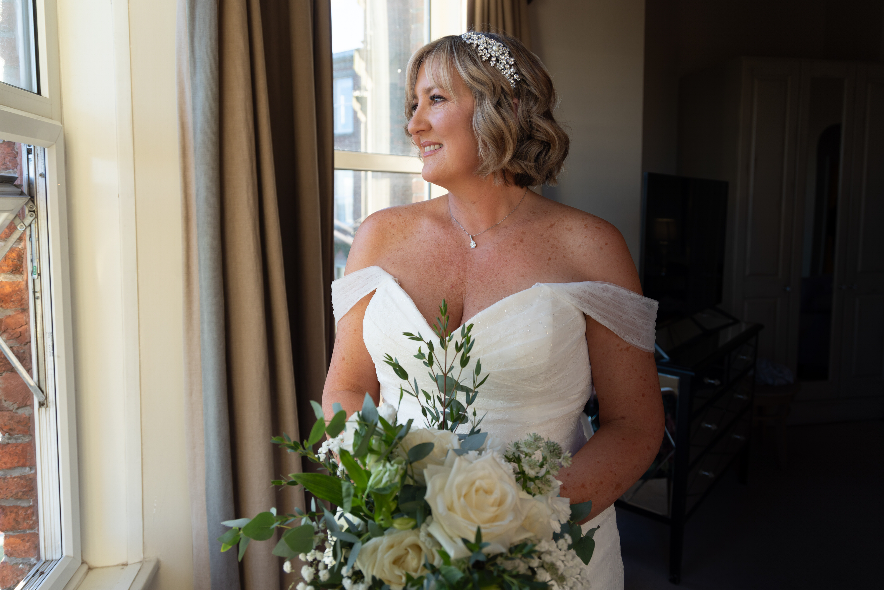 Lisa the Bride standing in front of the window 