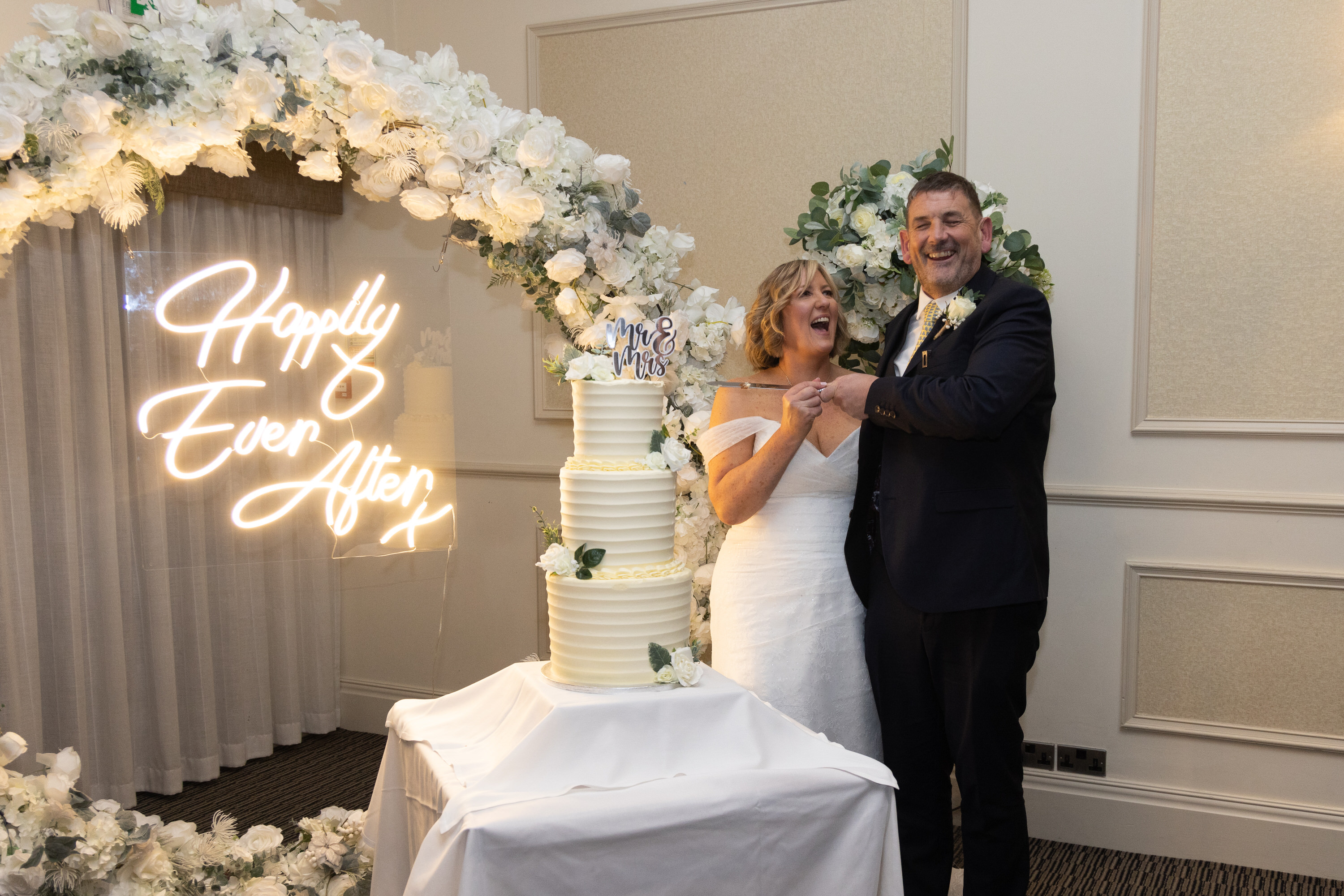The bride and groom cut the wedding cake 