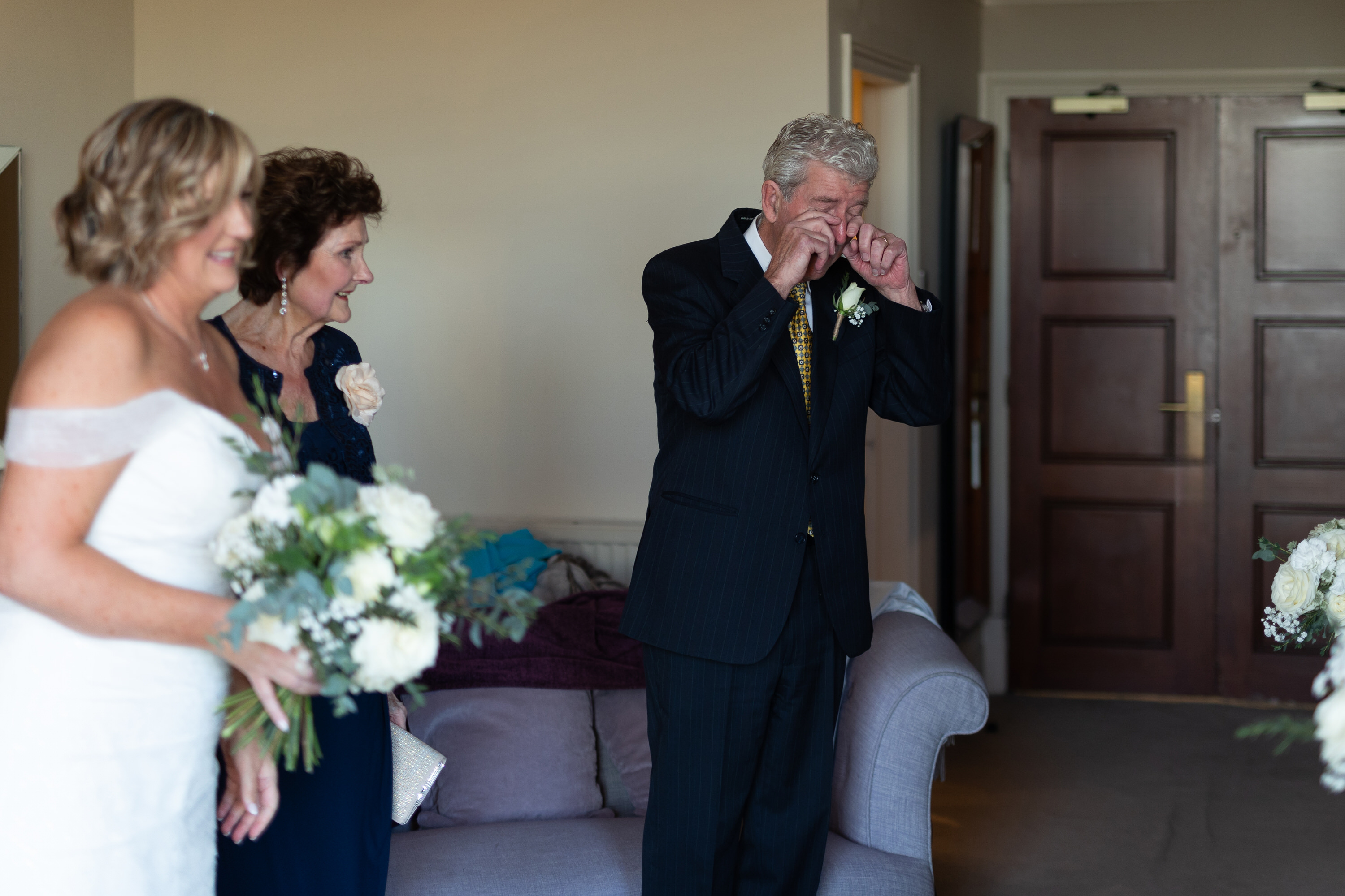 The father of the bride cries when he sees his daughter 