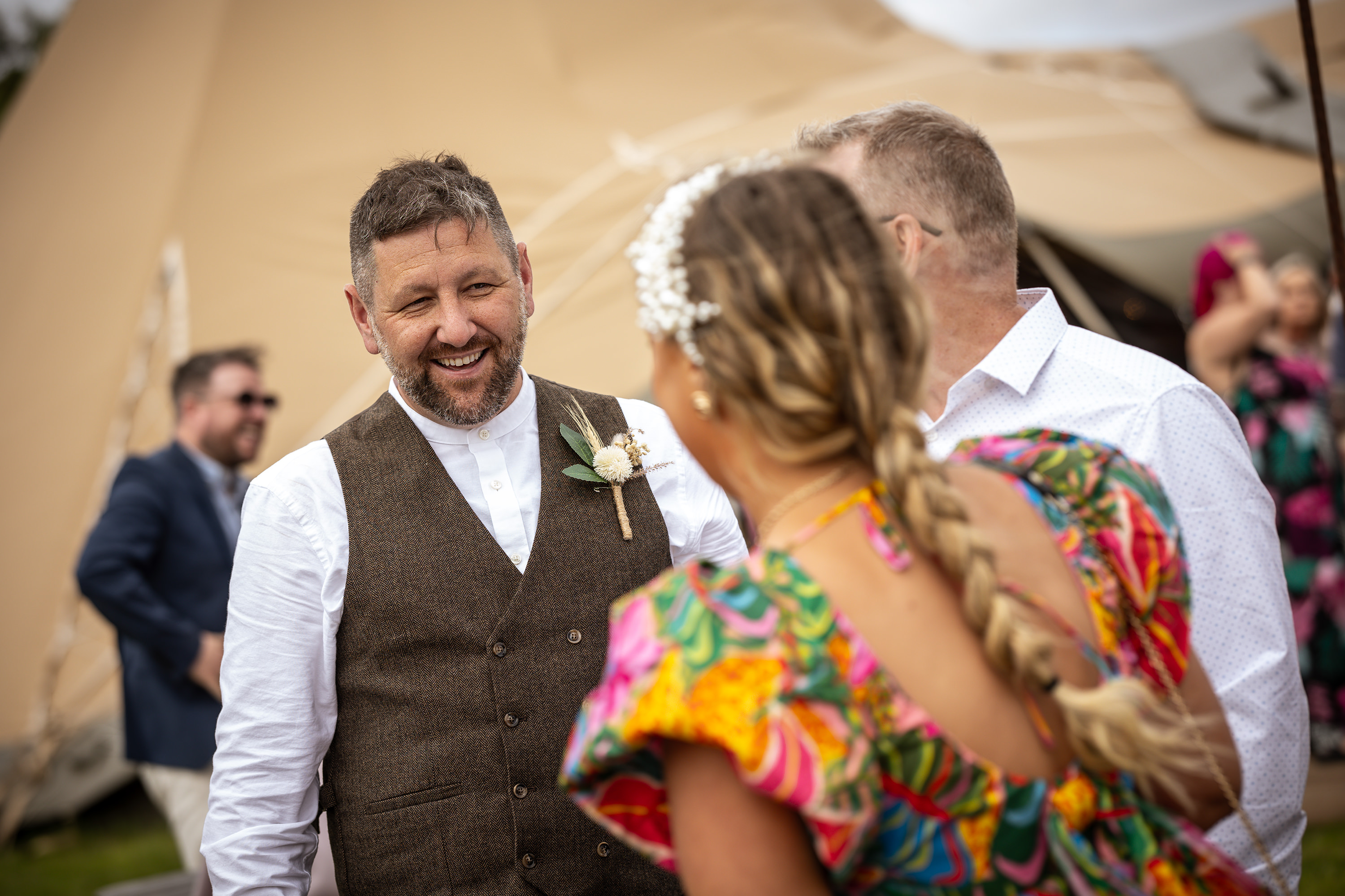 Daley the groom at the den at four Acre meeting the wedding guests