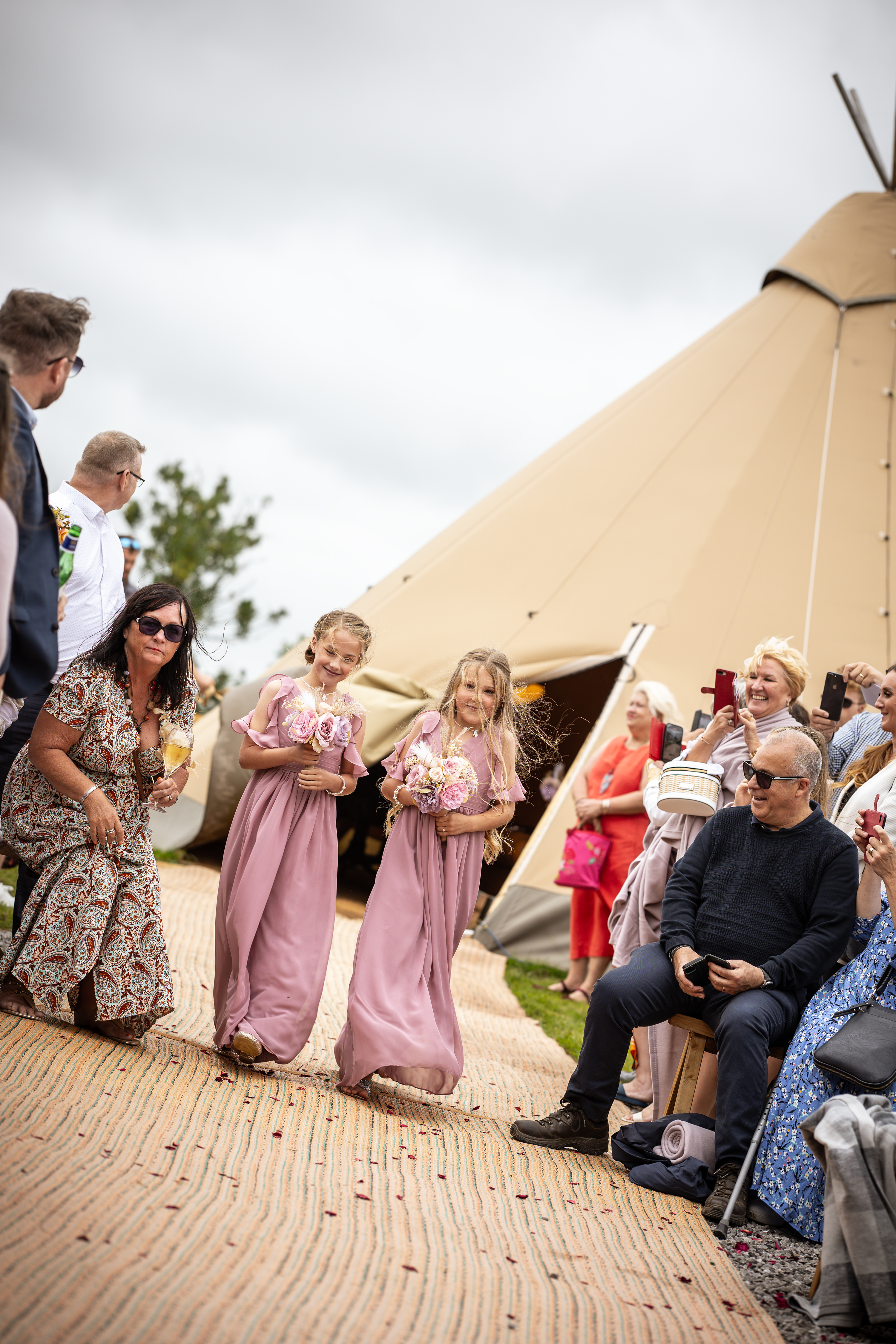 The bridesmaids and flower girls make their way down the aisle 