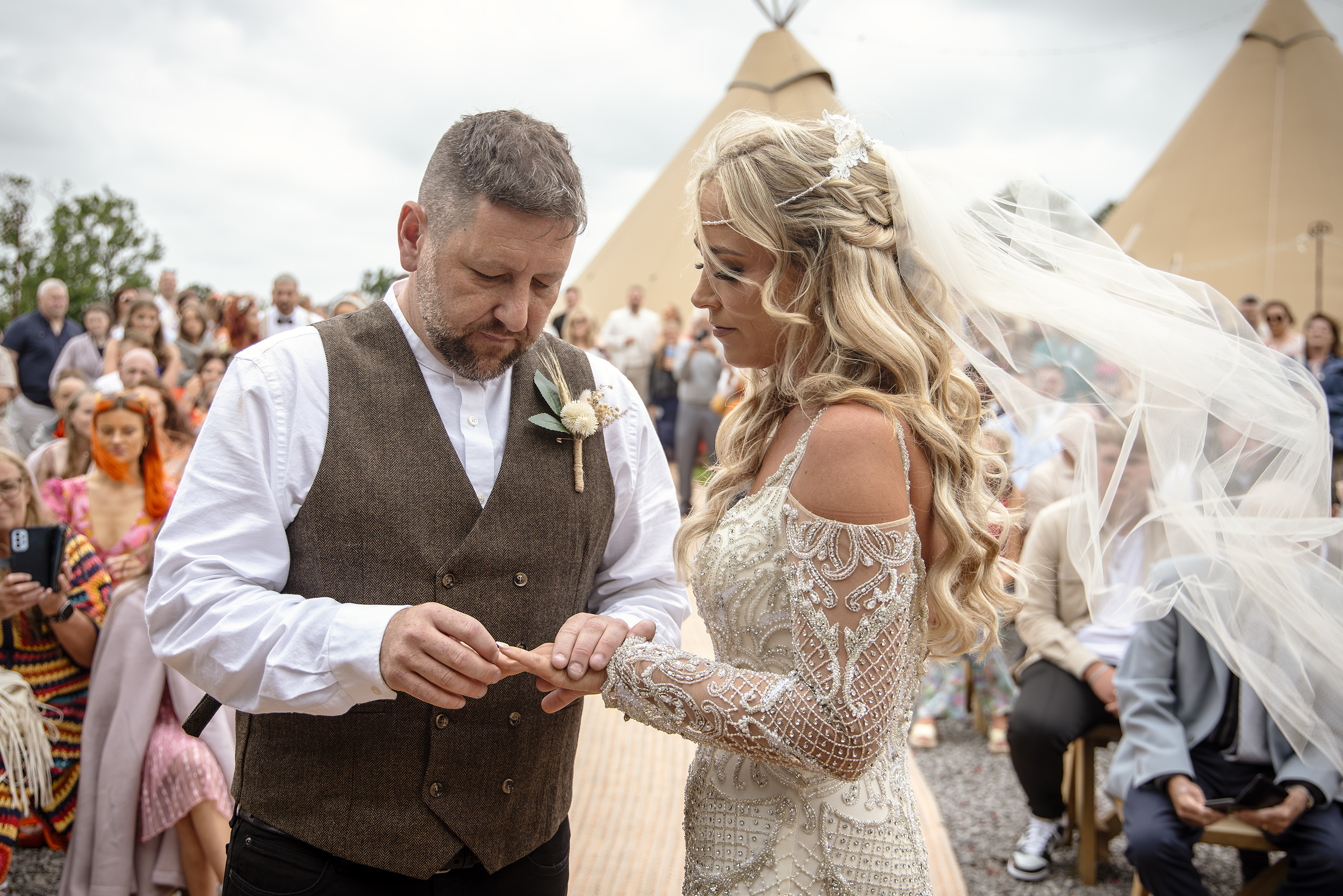 The groom Daley puts Samantha's wedding ring on her finger