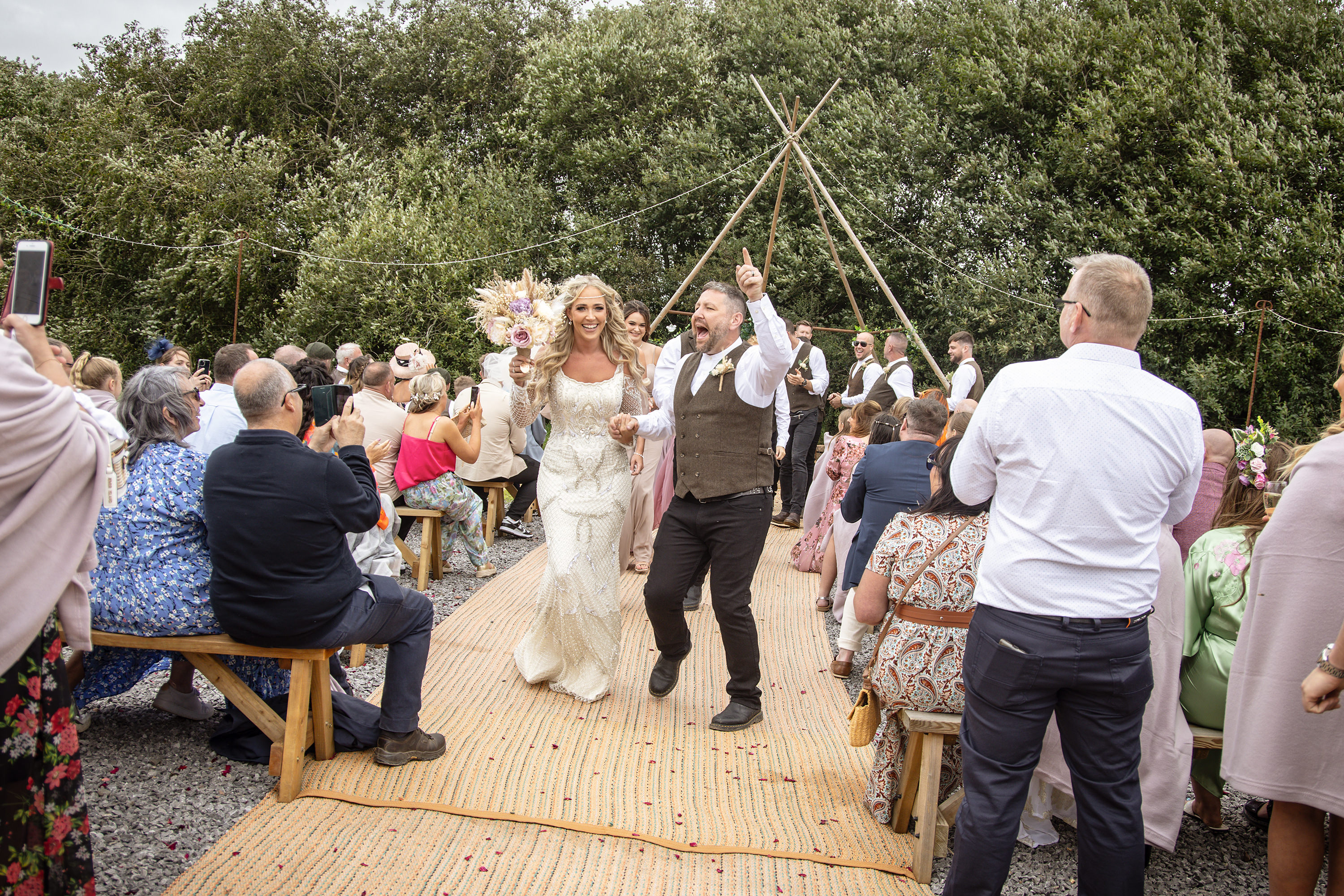 The bride and groom walked down the aisle husband and wife