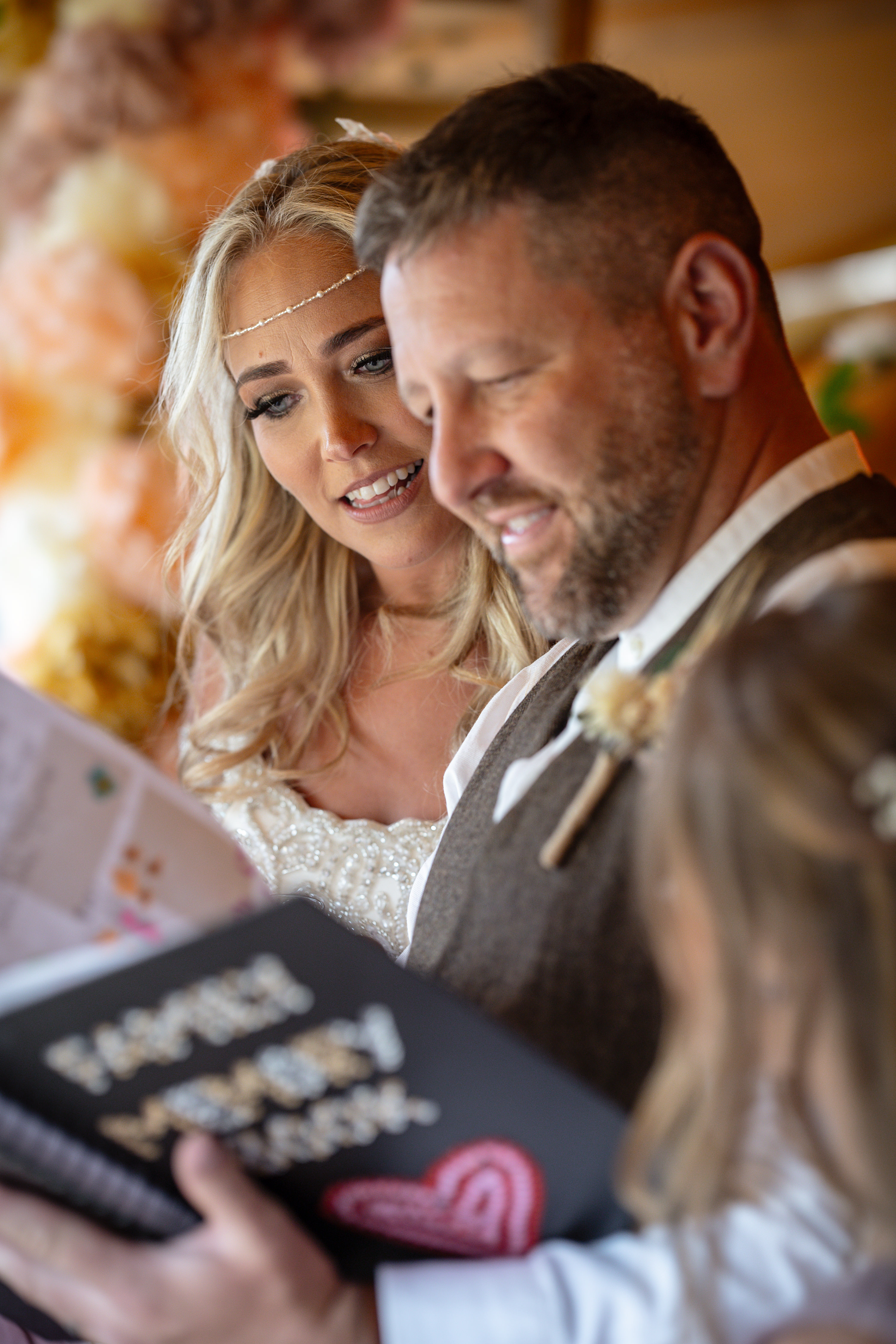 The bride and groom look through their family memory book 