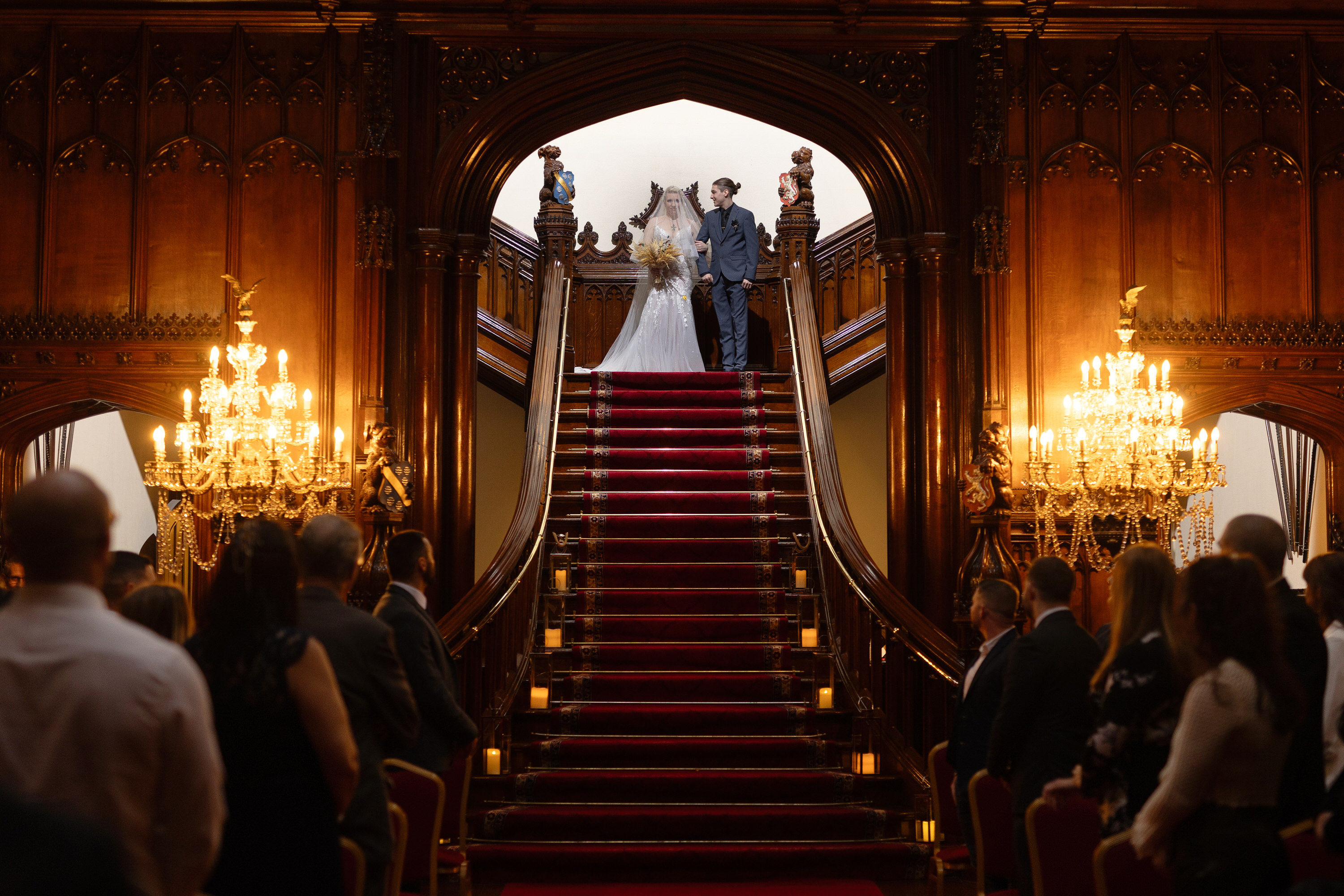 The bride and her son walk down the stairs 