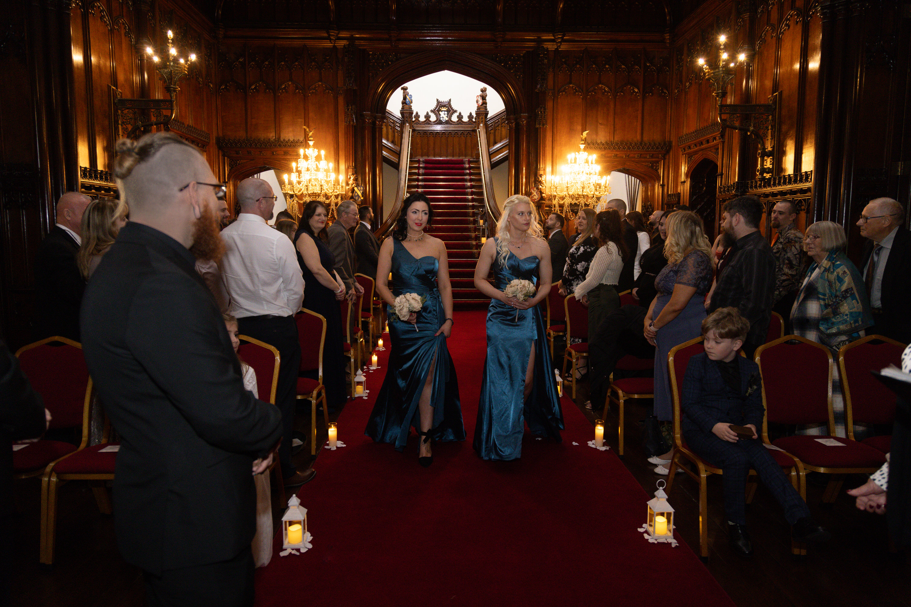 The bridesmaids make their way down the big staircase 