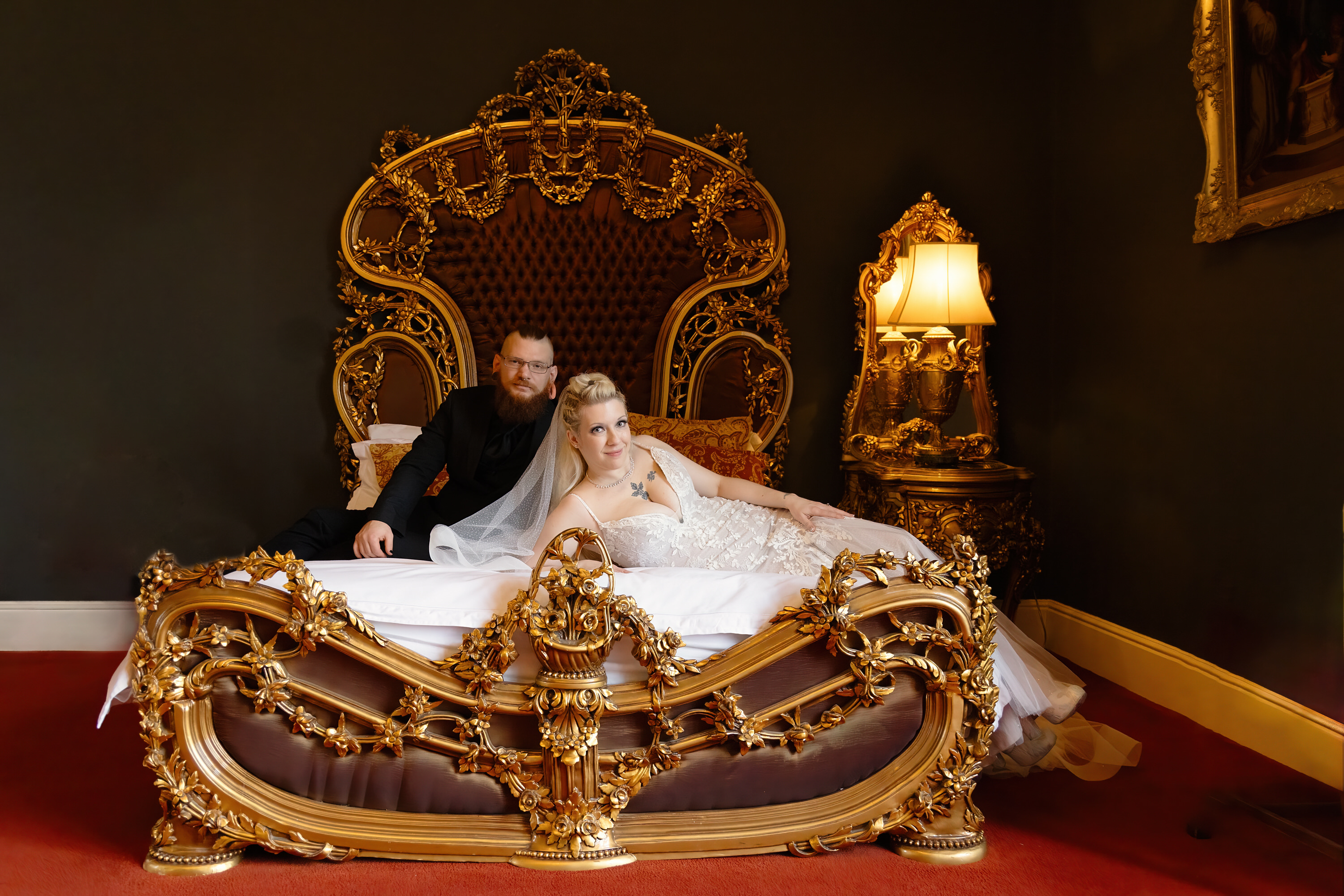 The bride and groom pose for photos in the bridal suite 