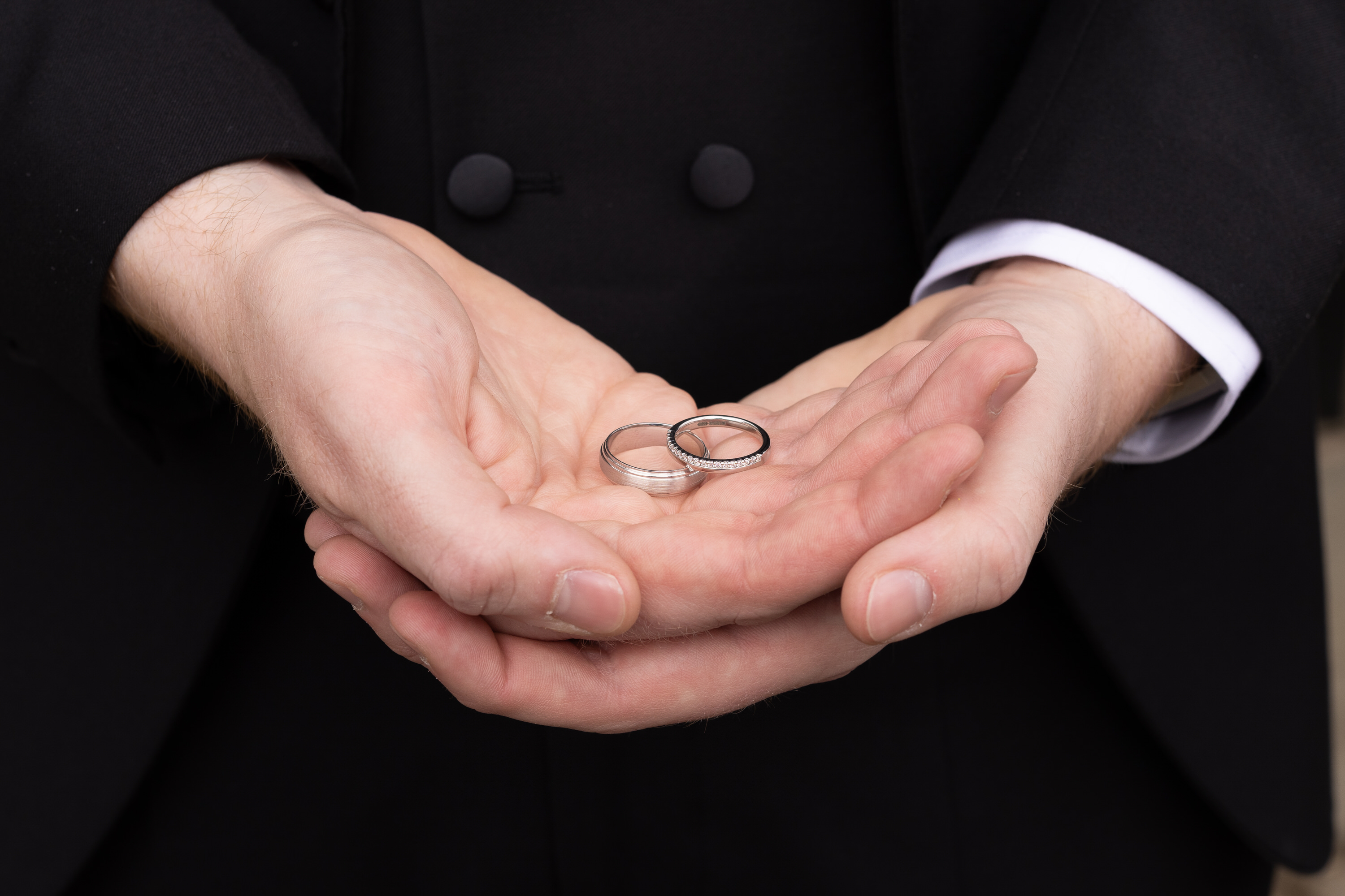 The best man holding the wedding rings 