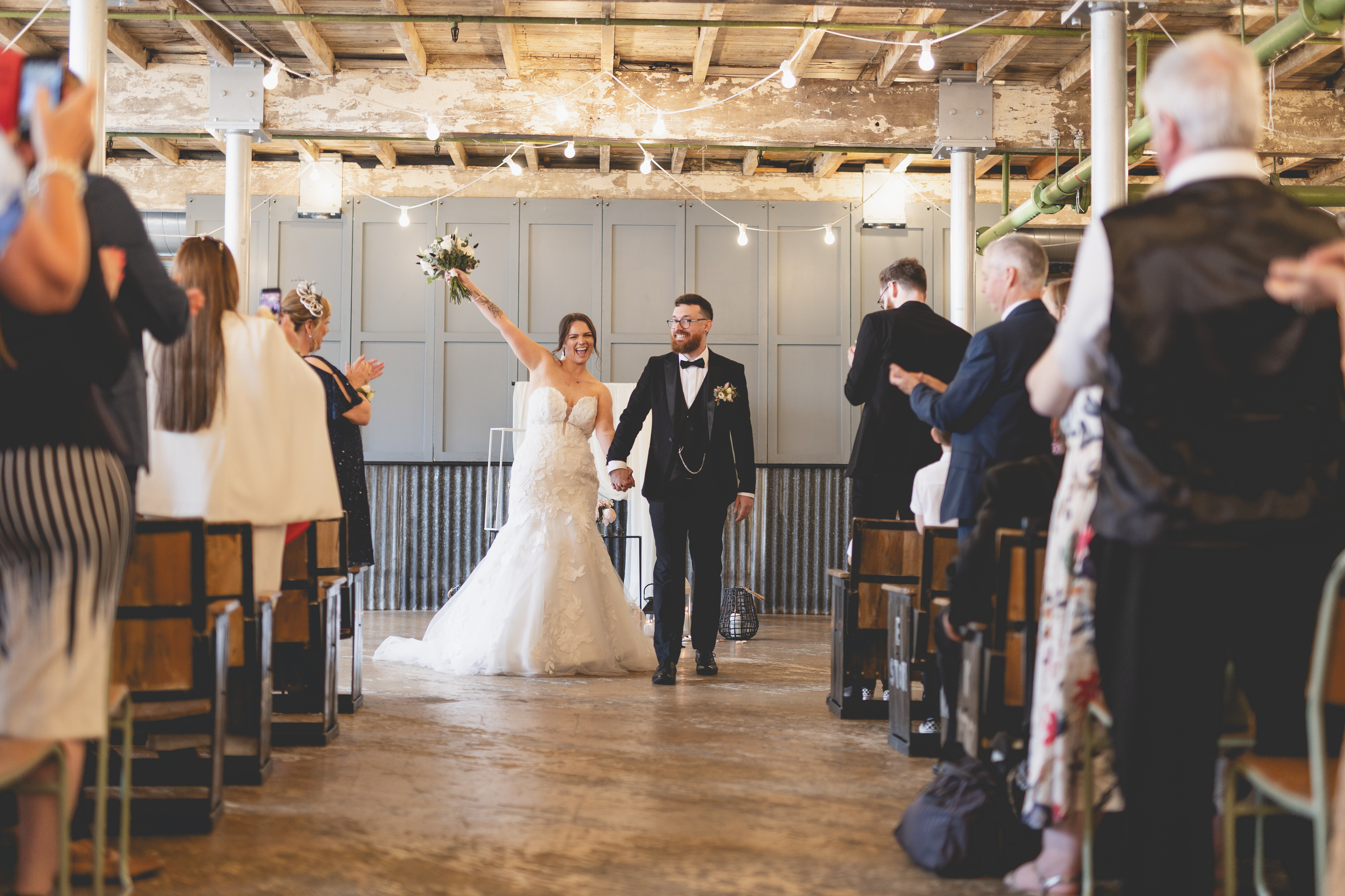 The happy bride and groom walk down the aisle