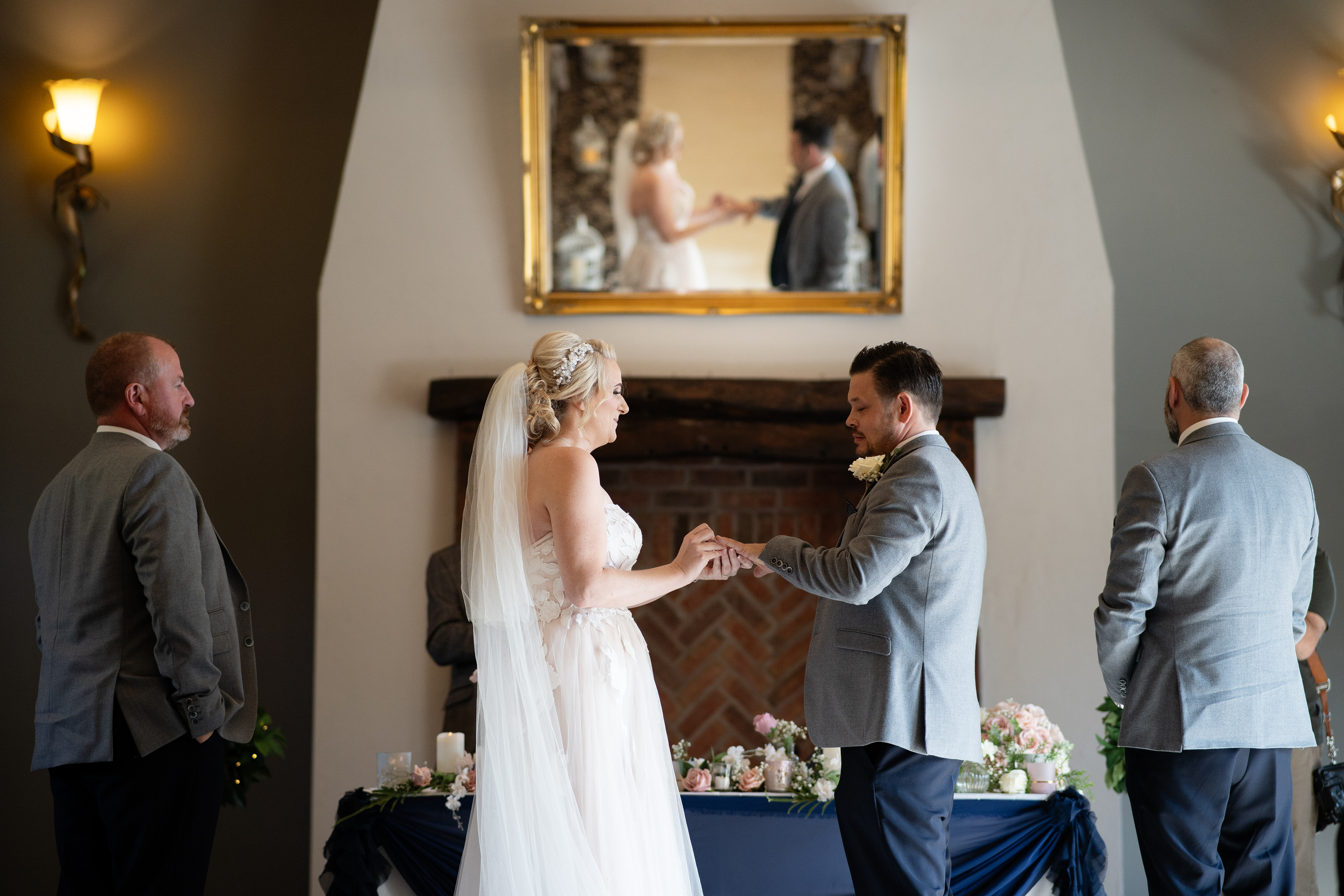 The bride and groom exchange wedding rings 