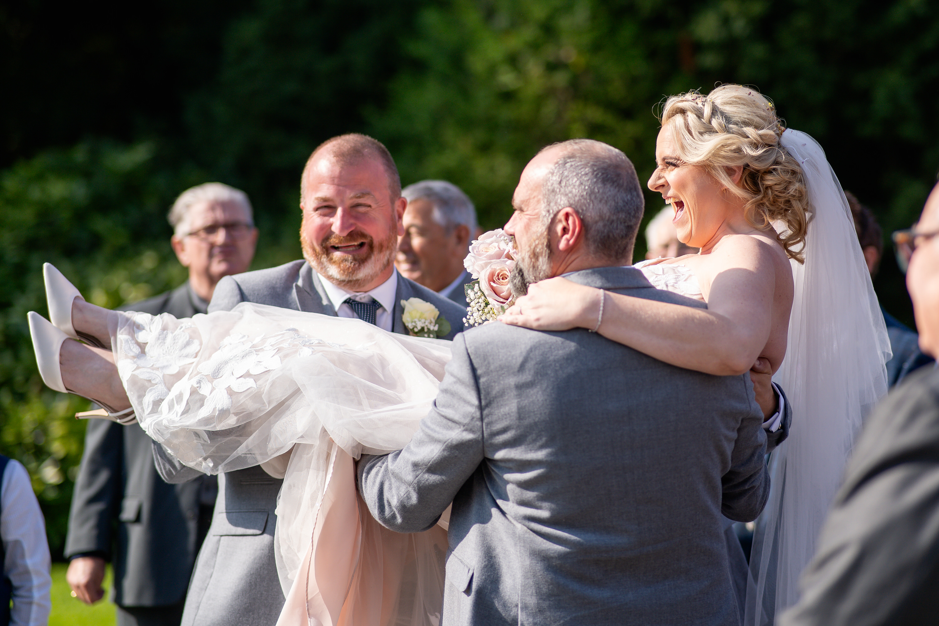 The men throw the Bride in the air 
