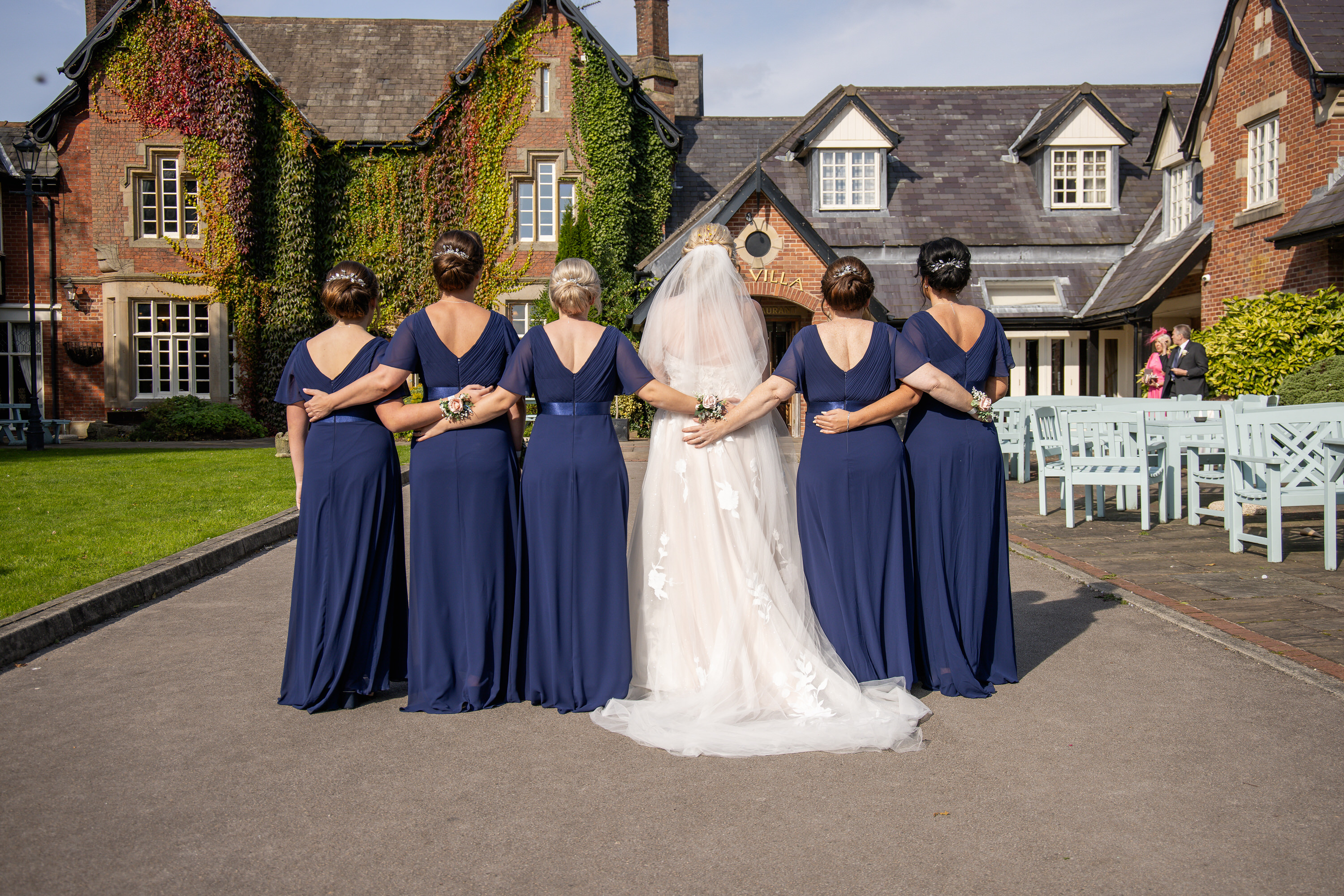 The bride and her bridesmaids re-enact a photo 