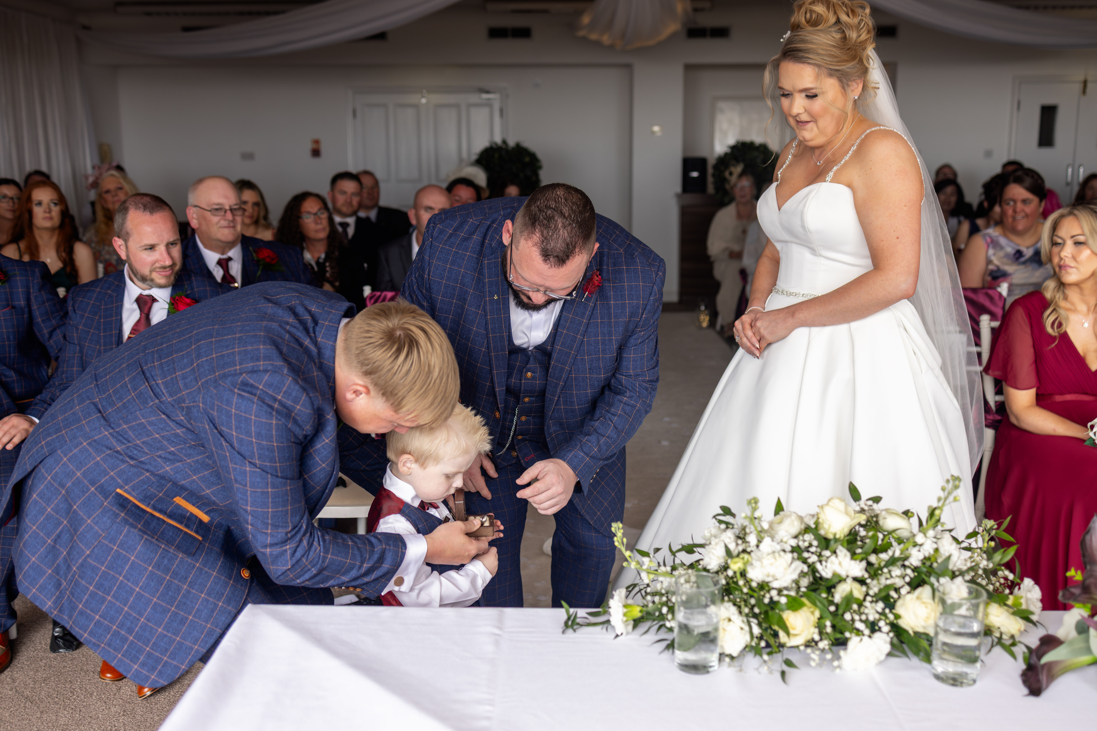The page boy brings in the wedding rings 