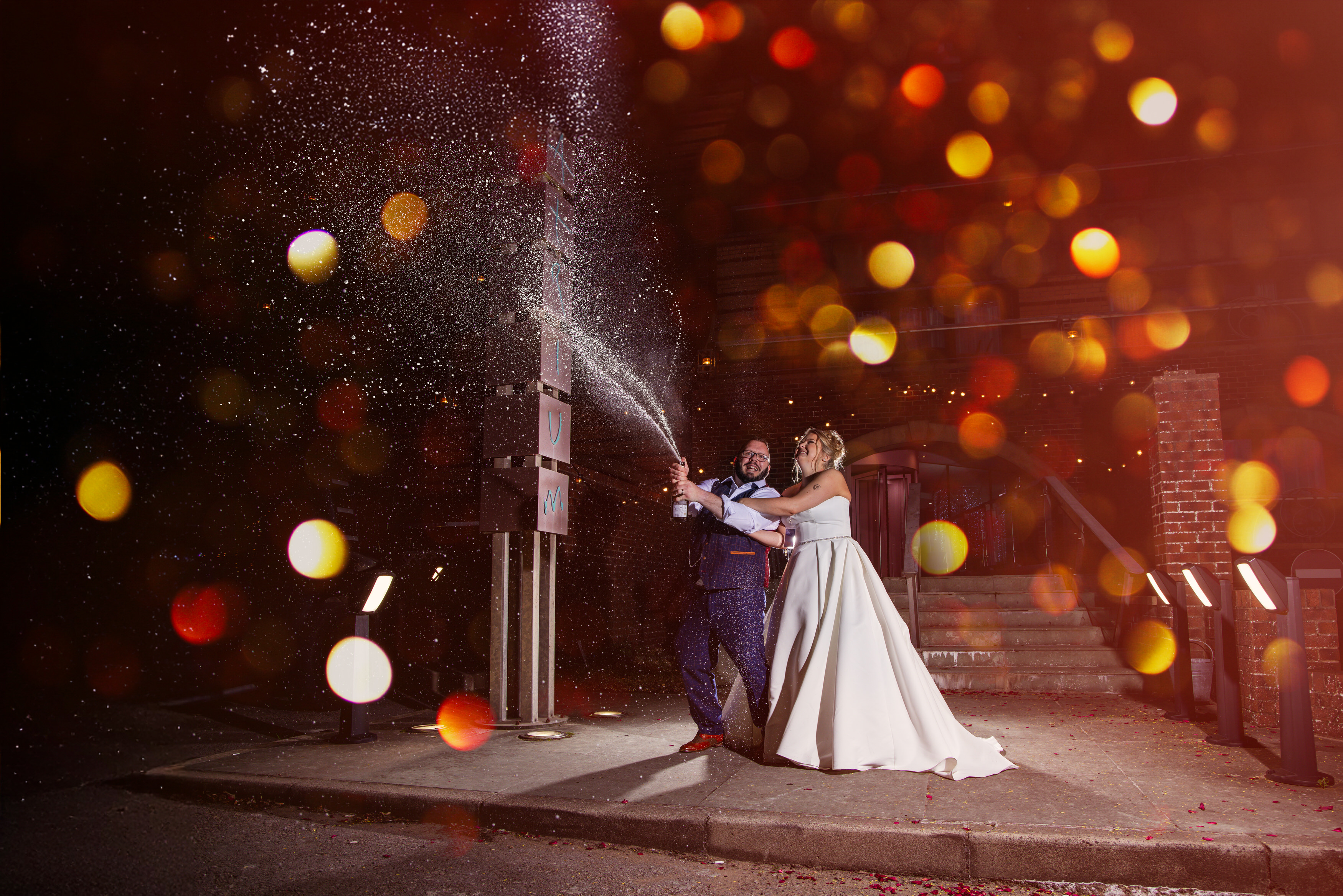 The bride and groom pop the champagne