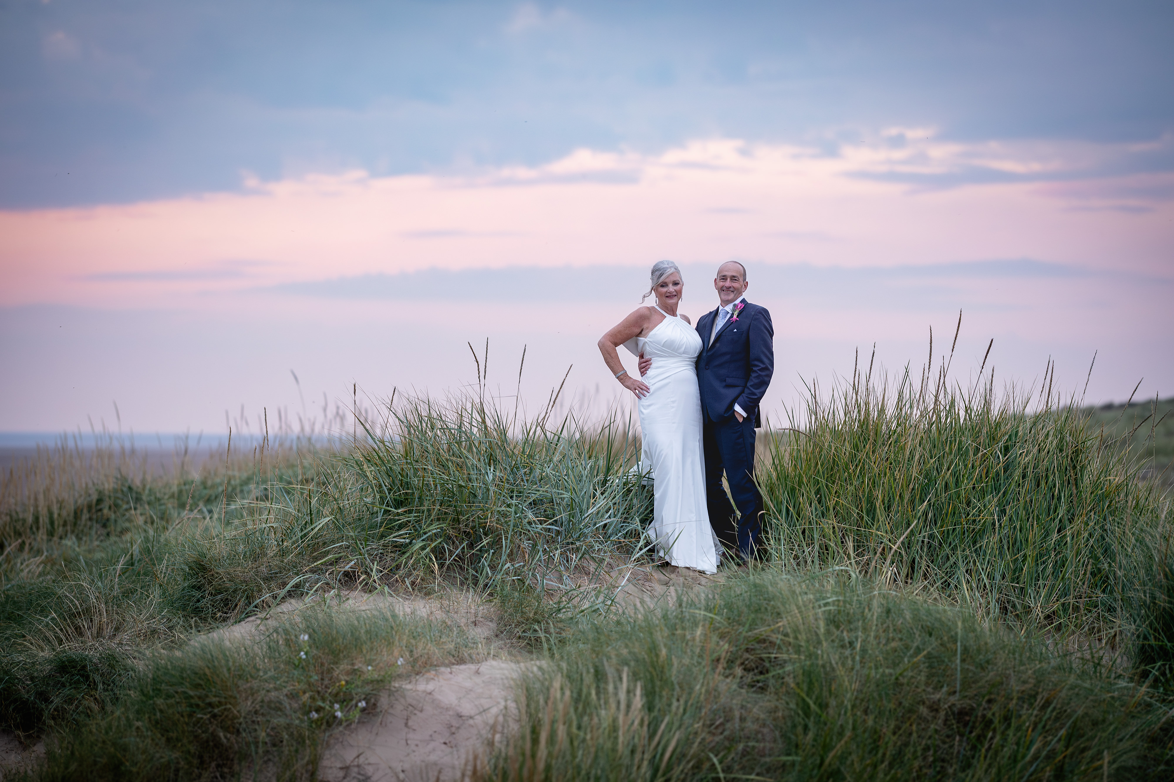 The bride and groom on the sand dunes