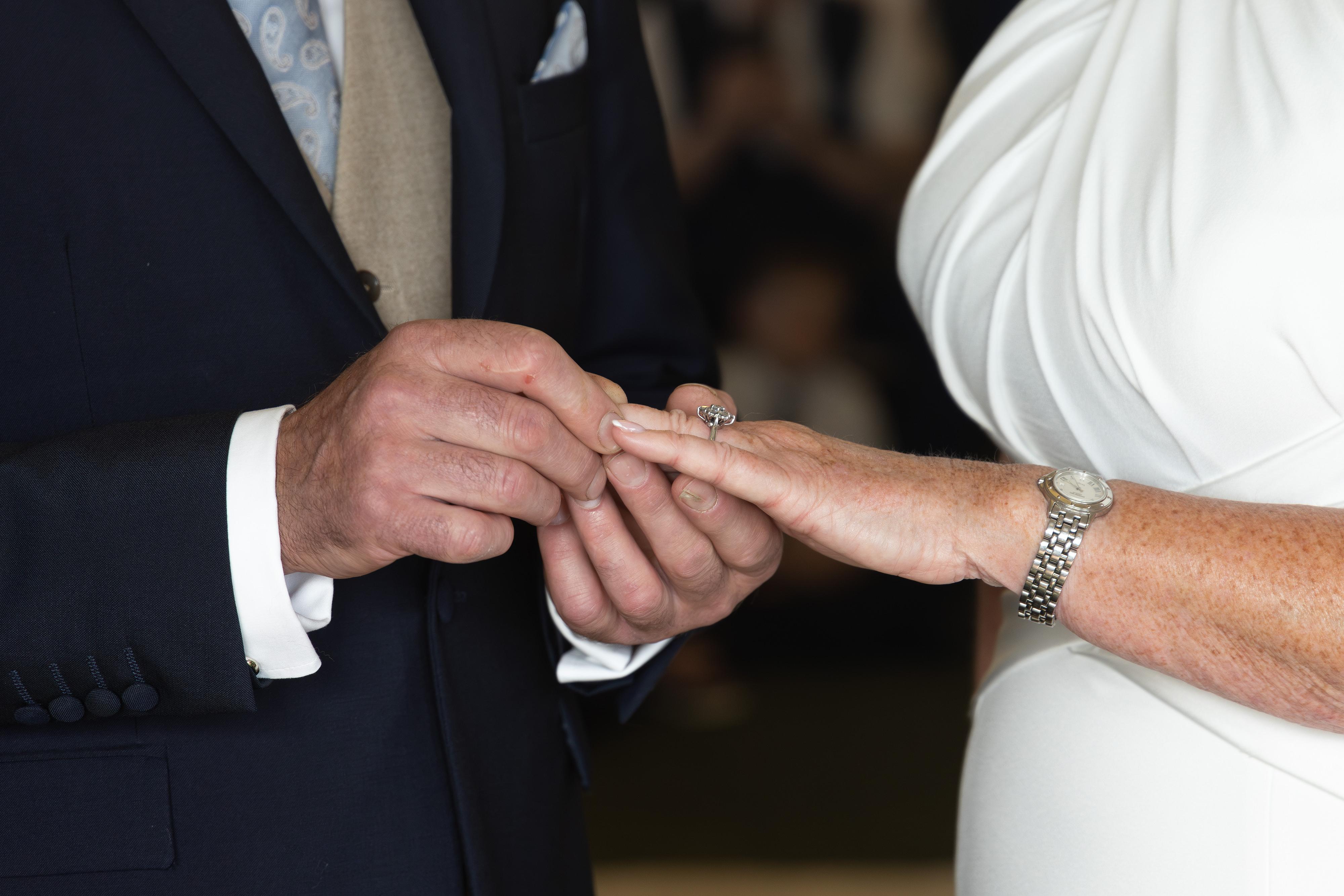 The groom places the ring on the Brides finger 