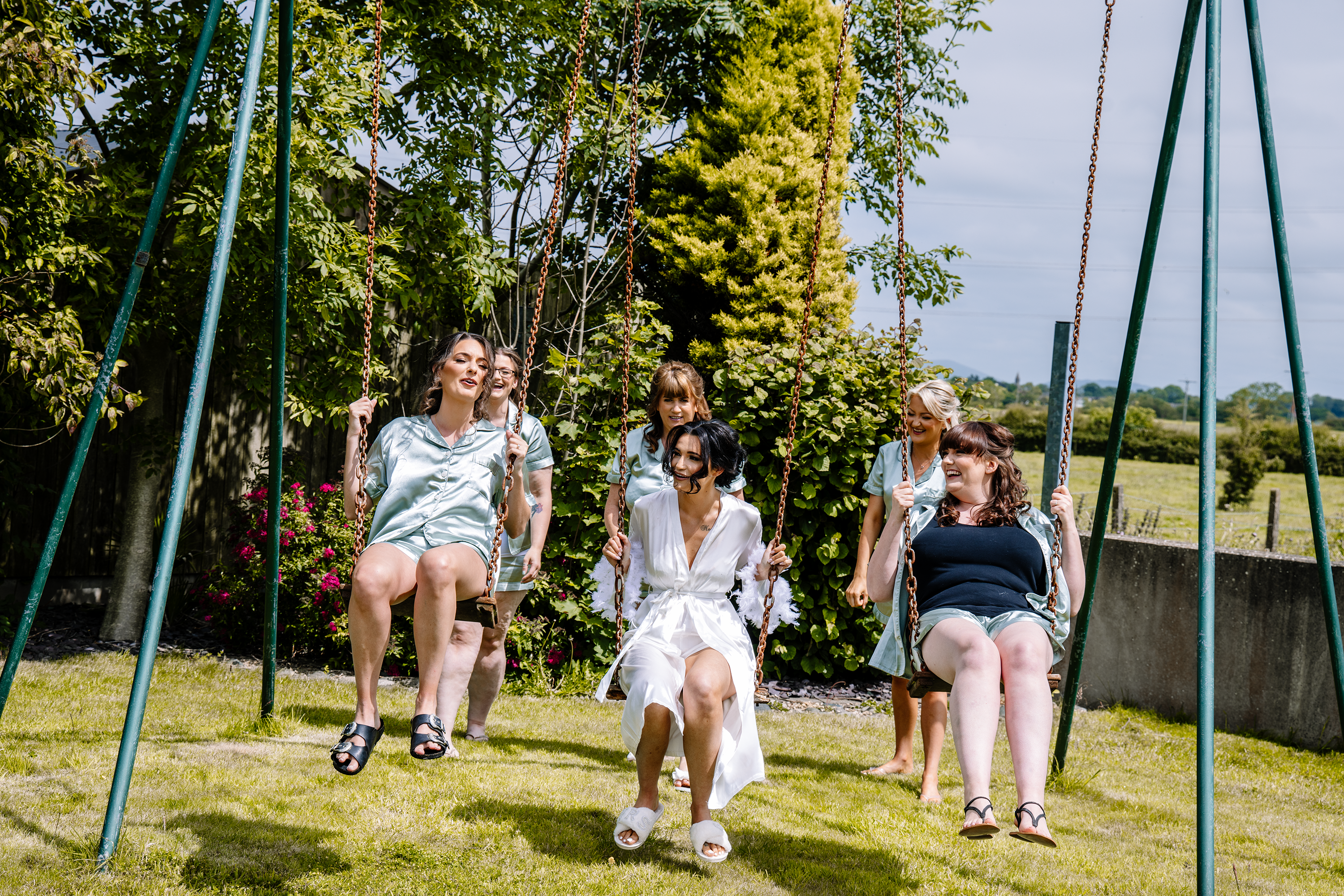 Christina and the bridesmaids on the swings 