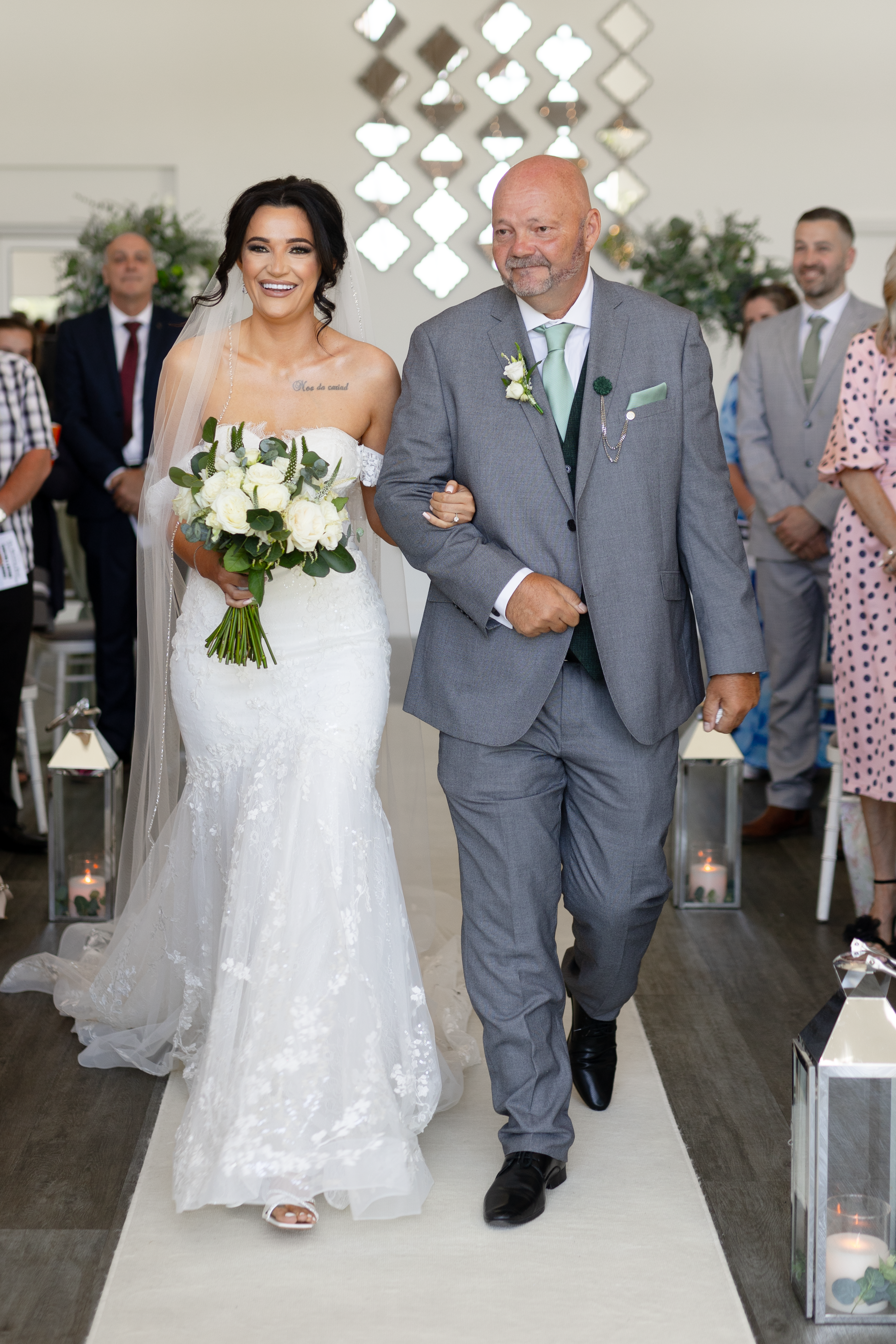 Christina walks up the aisle with her father 