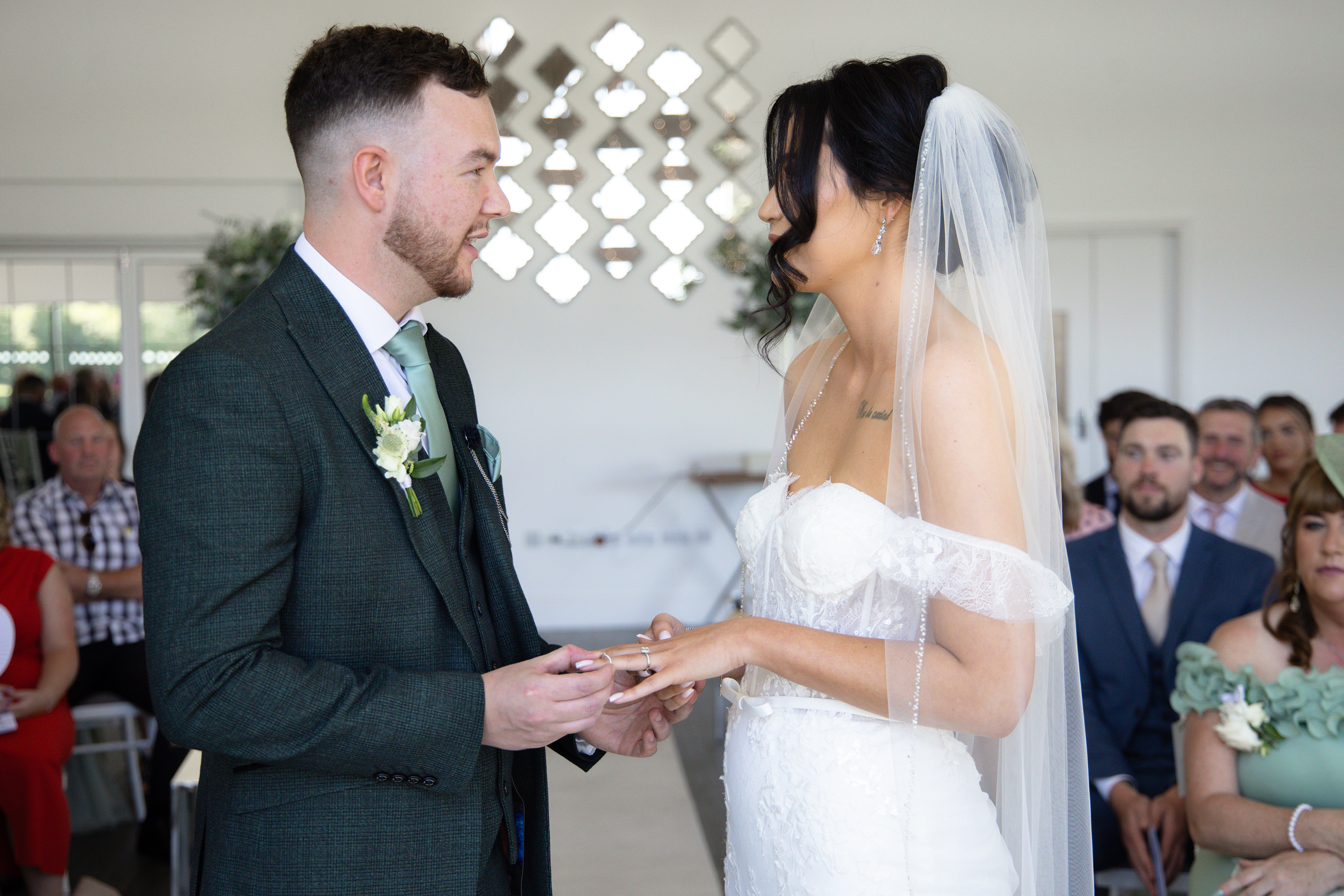 The bride and groom exchange wedding rings 