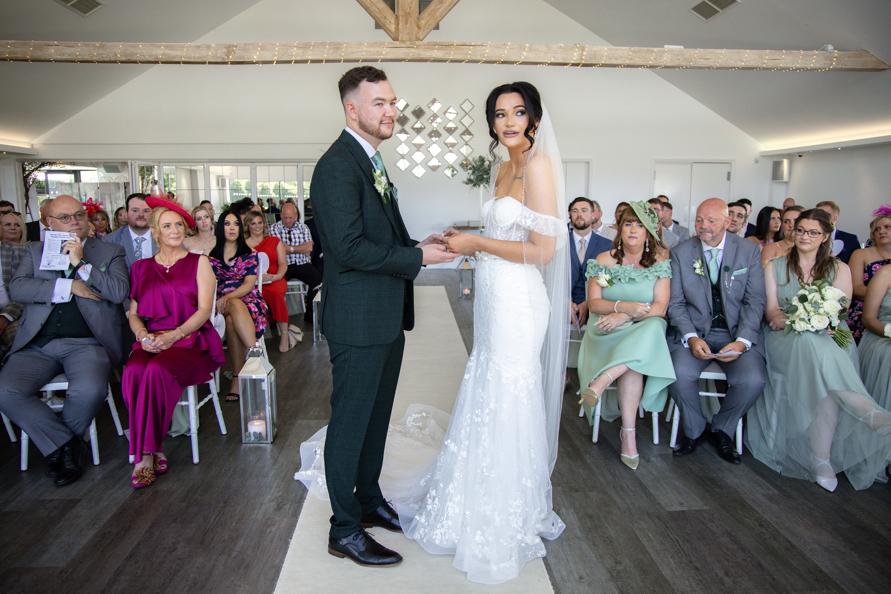 The bride and groom exchange wedding rings 