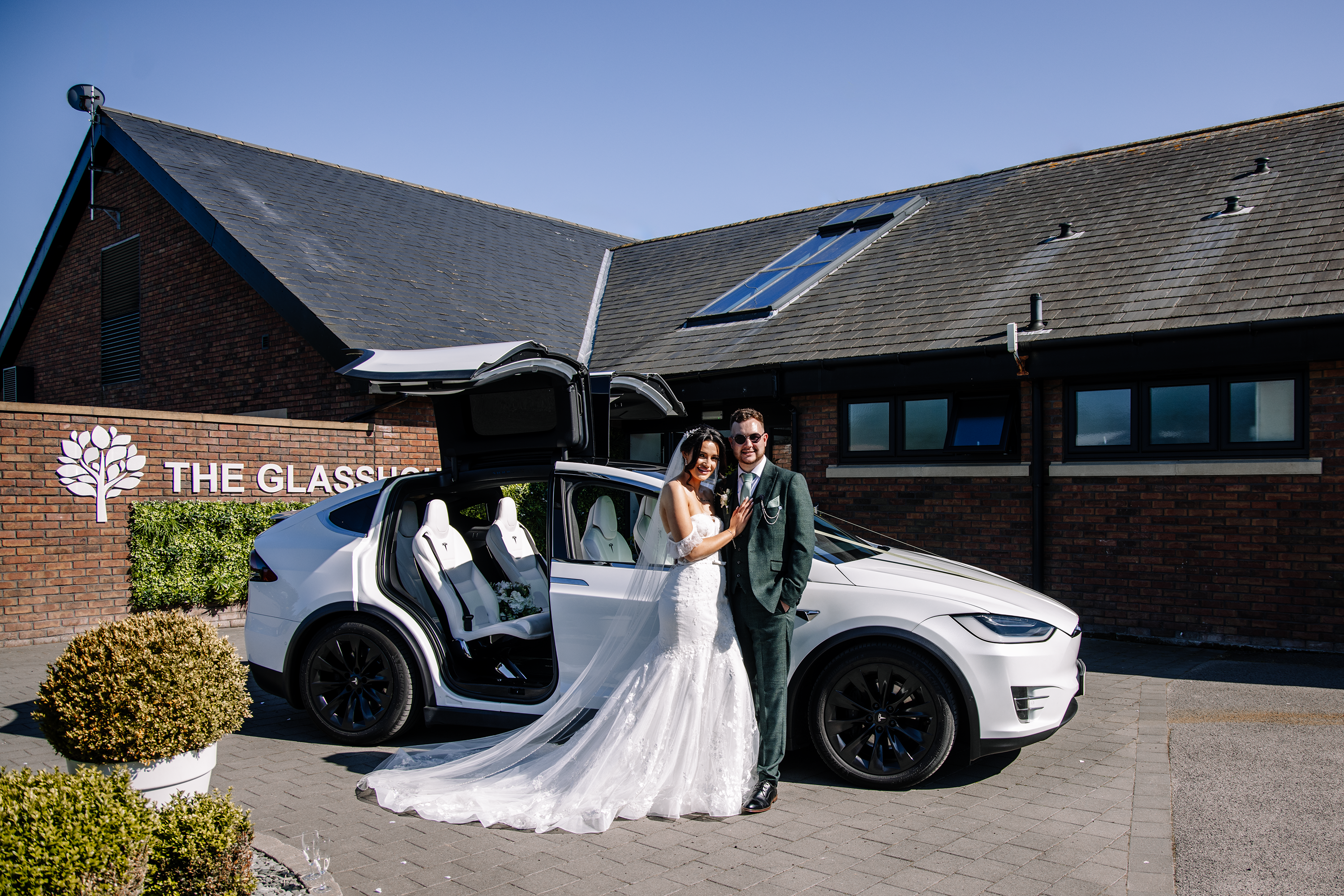 The Bride and groom with their wedding car