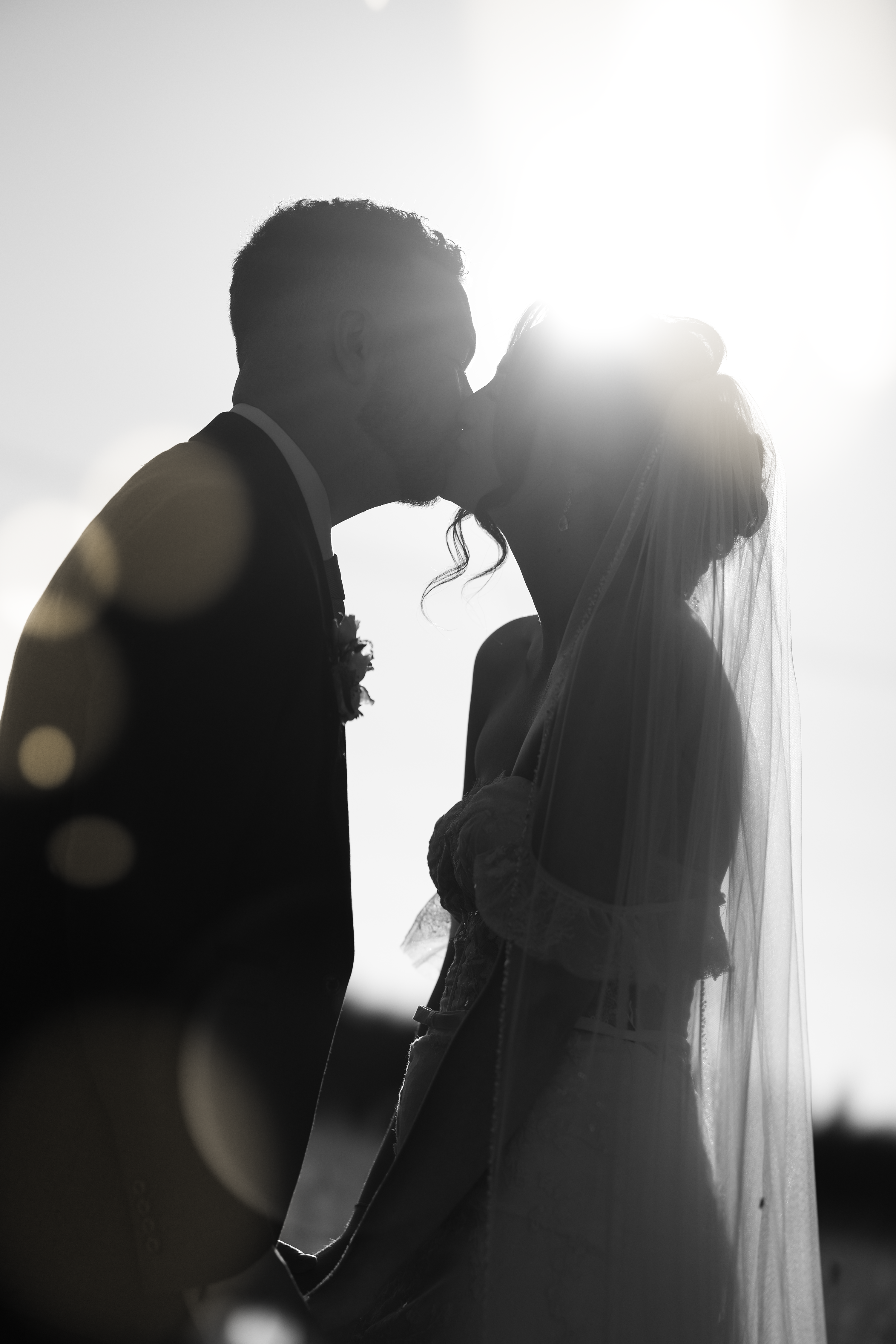 The couple having a kiss in the sunshine 