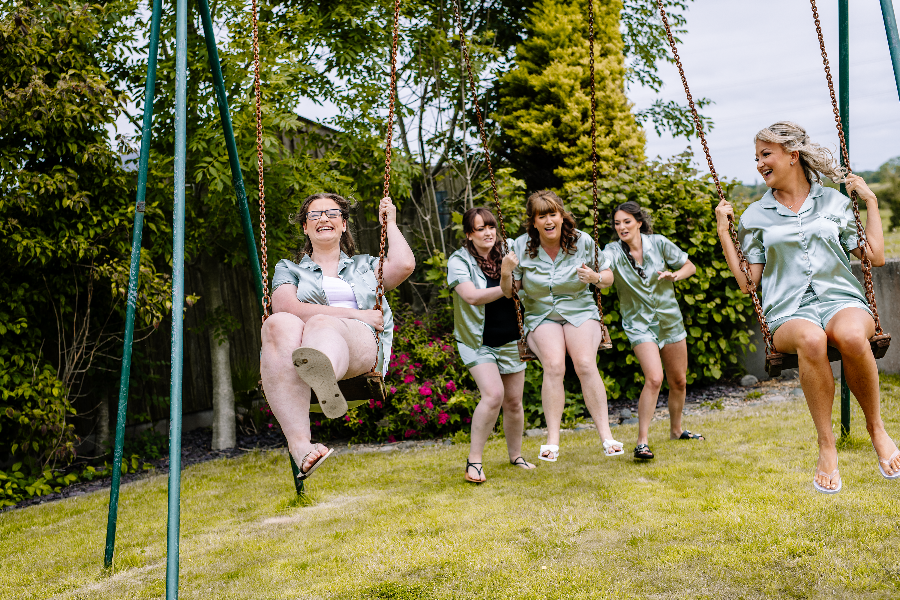 The bridesmaids having fun on the swings 