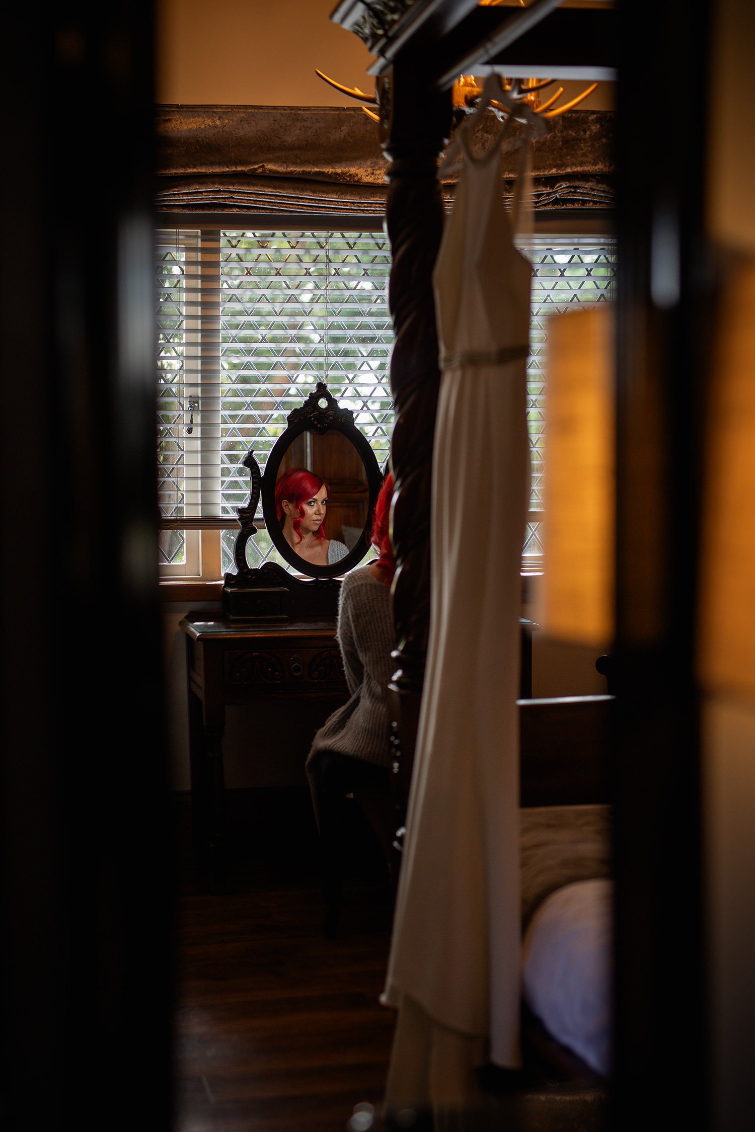 Stacey looking in the mirror with her wedding dress 