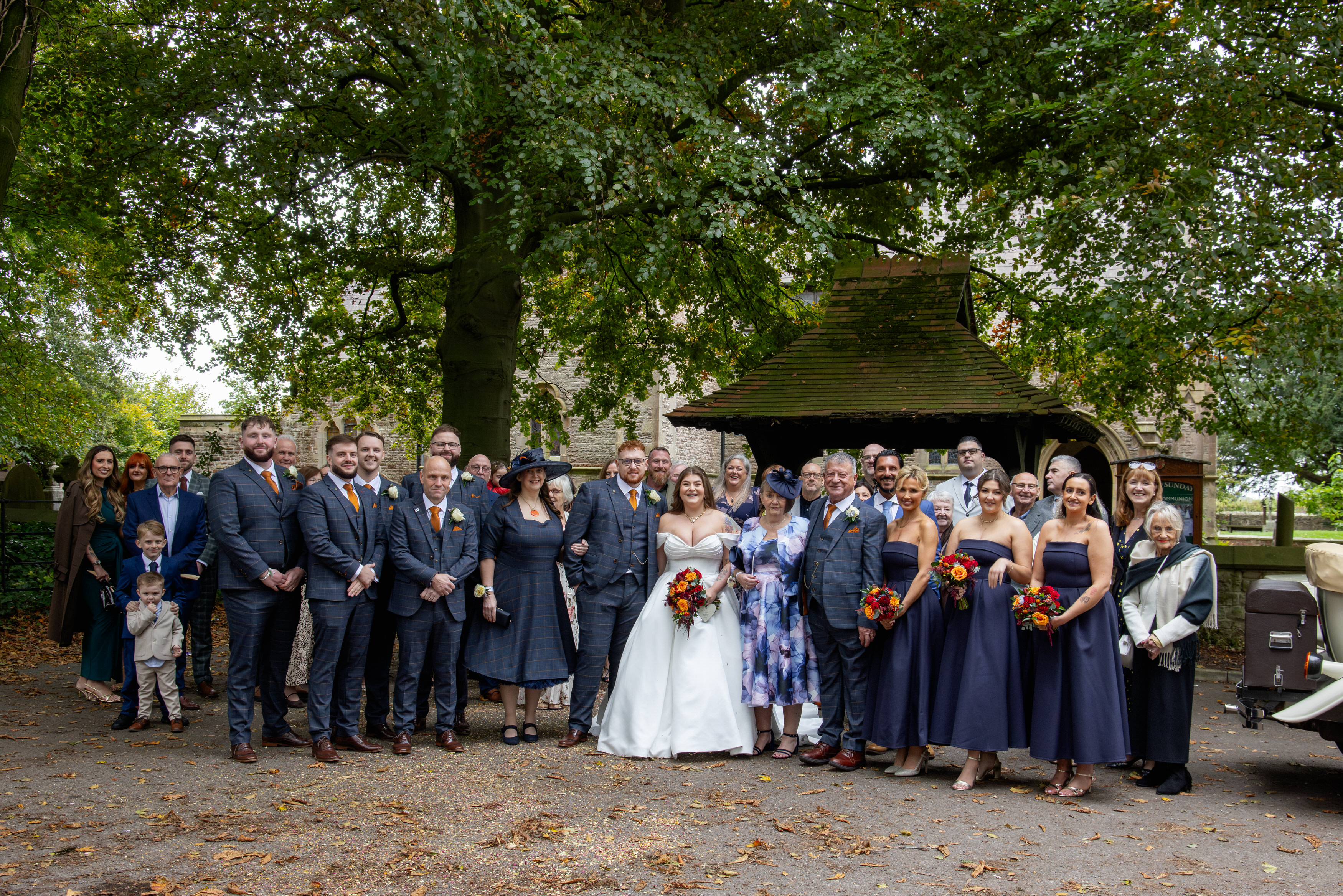 A happy couple have a photo with all their wedding guests 