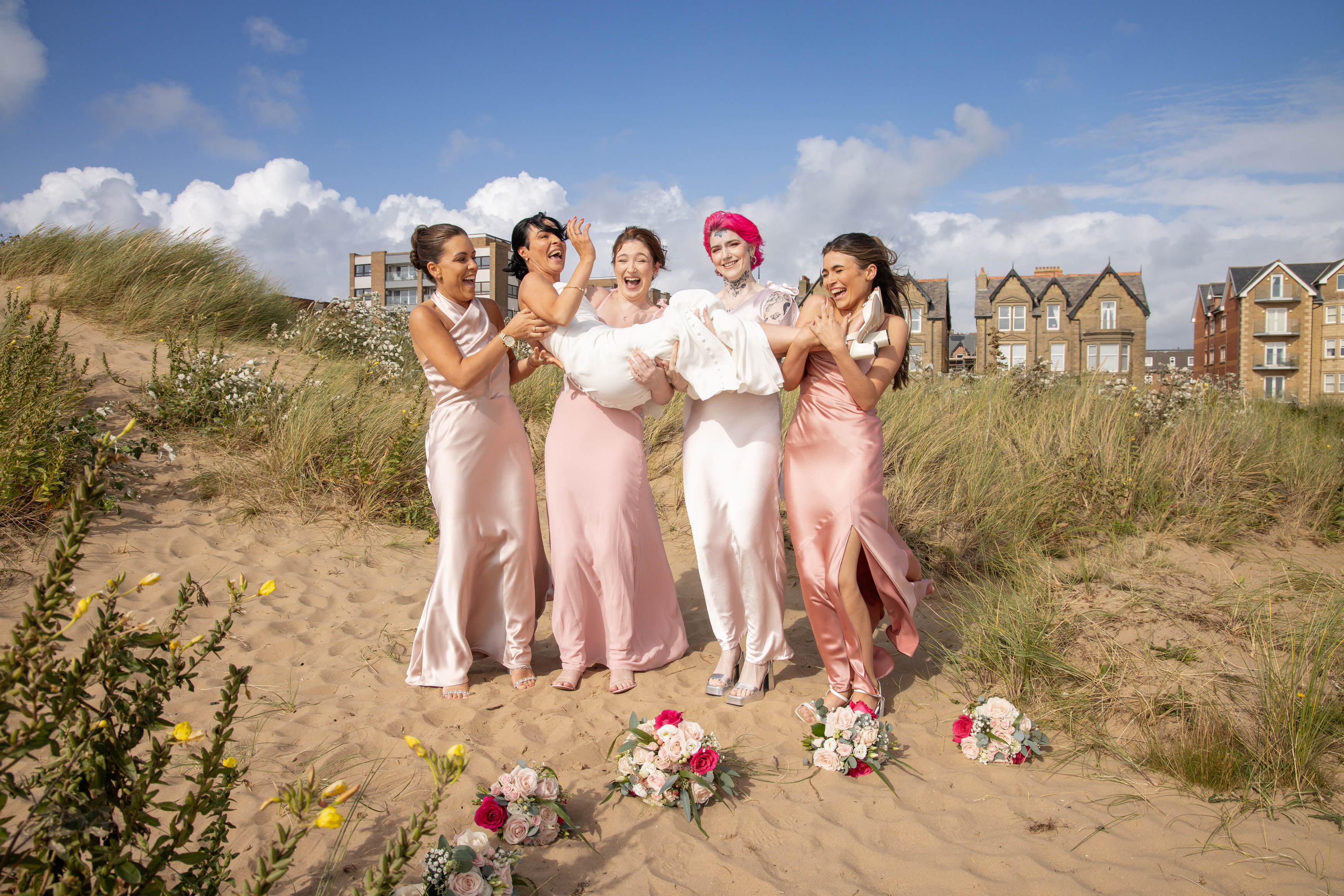 The bridesmaids pick up the Bride 