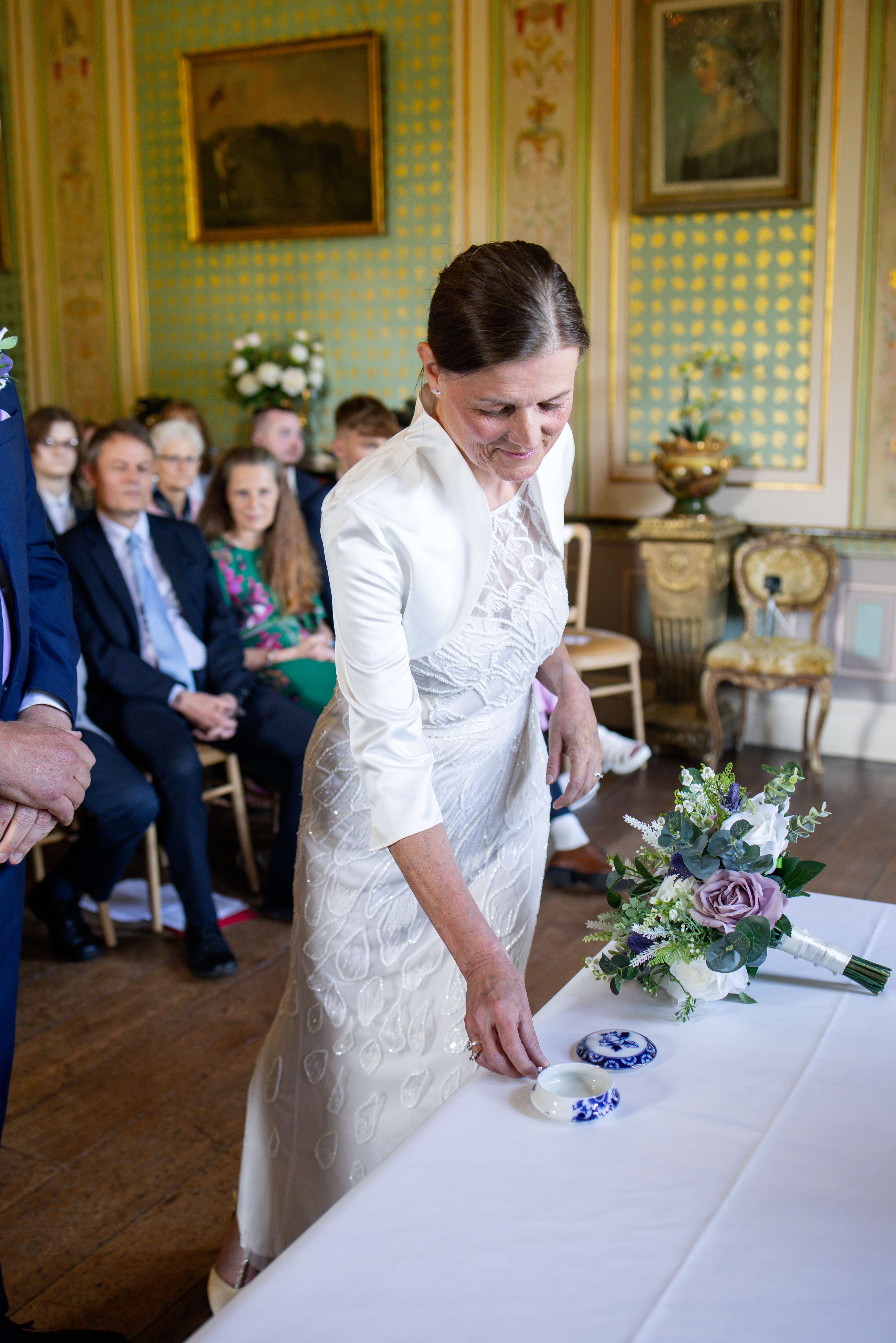 Helen reaches down to pick up Michael's ring 