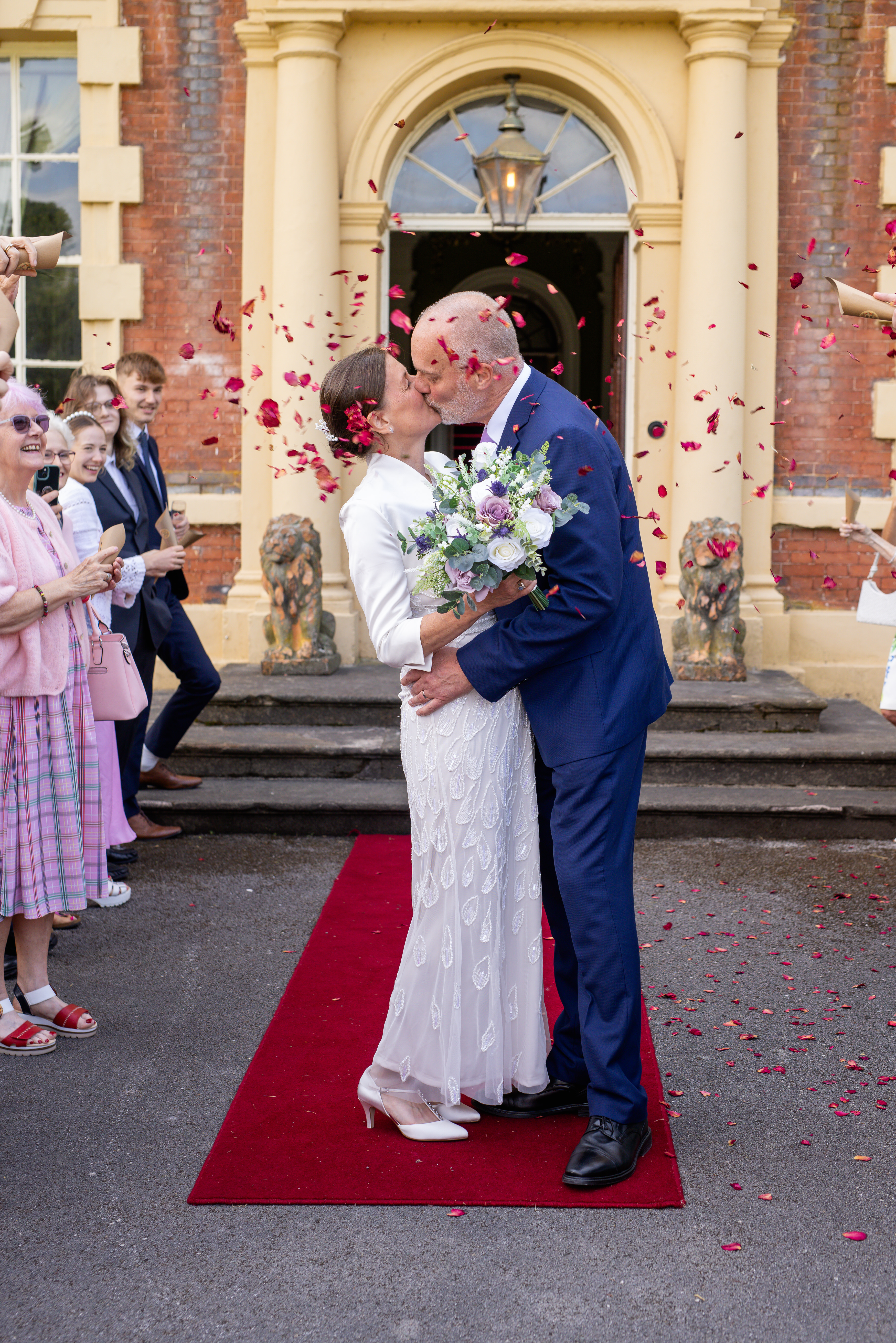 The guests throw confetti at the bride and groom 