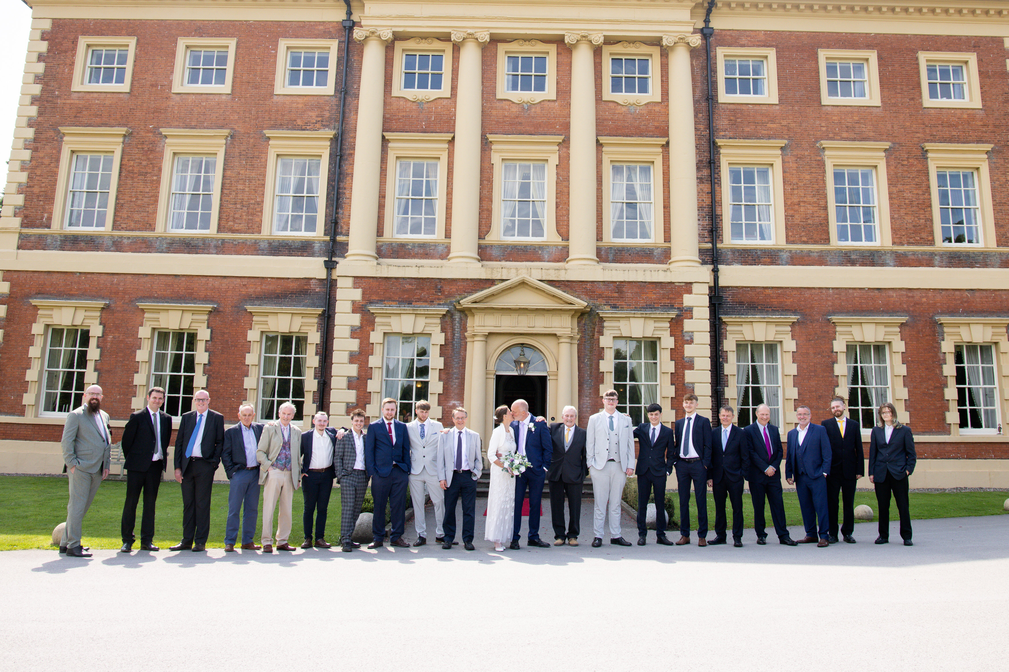 The bride and groom with all the men at the wedding 