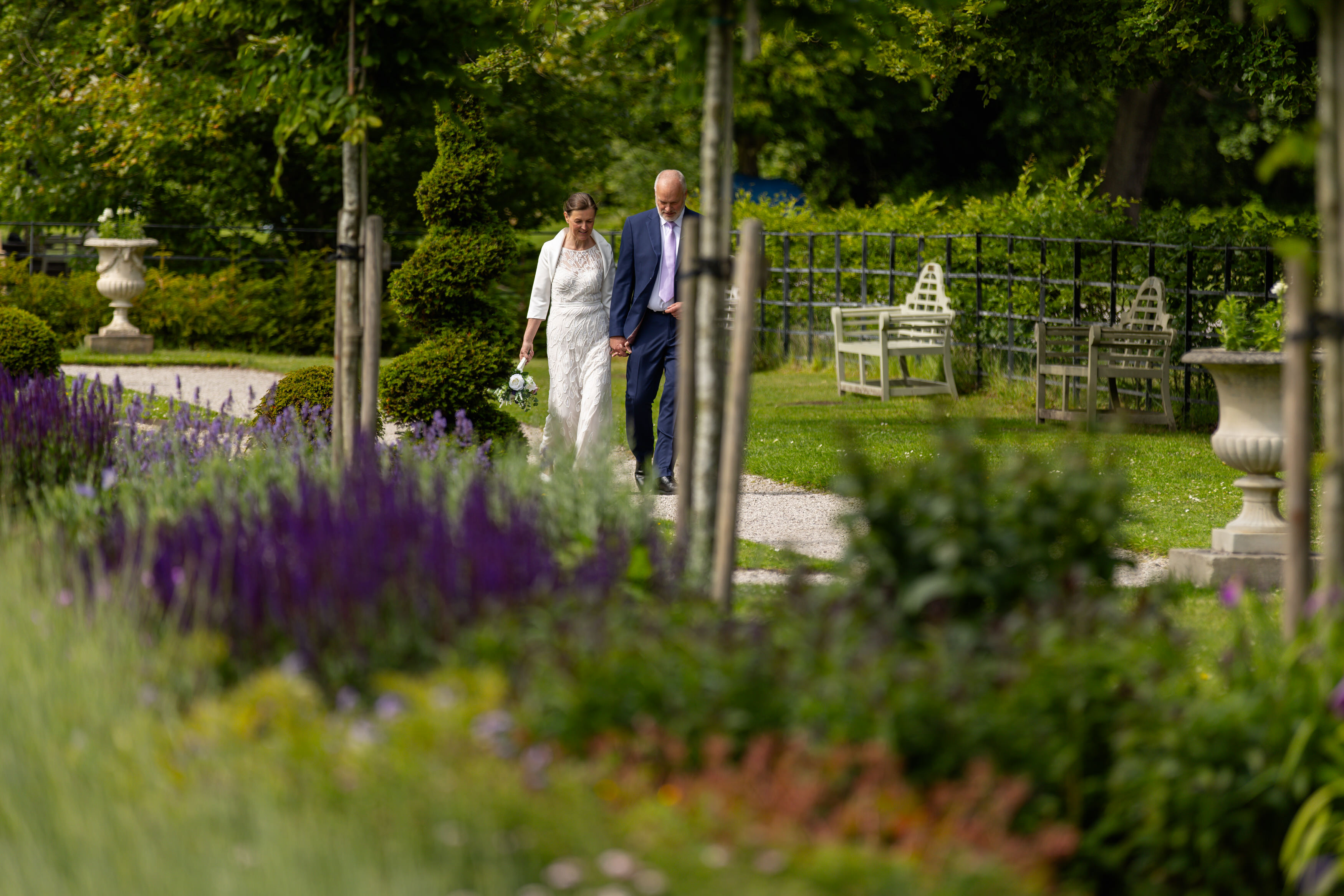The bride and groom walk in the grounds of Lytham Hall
