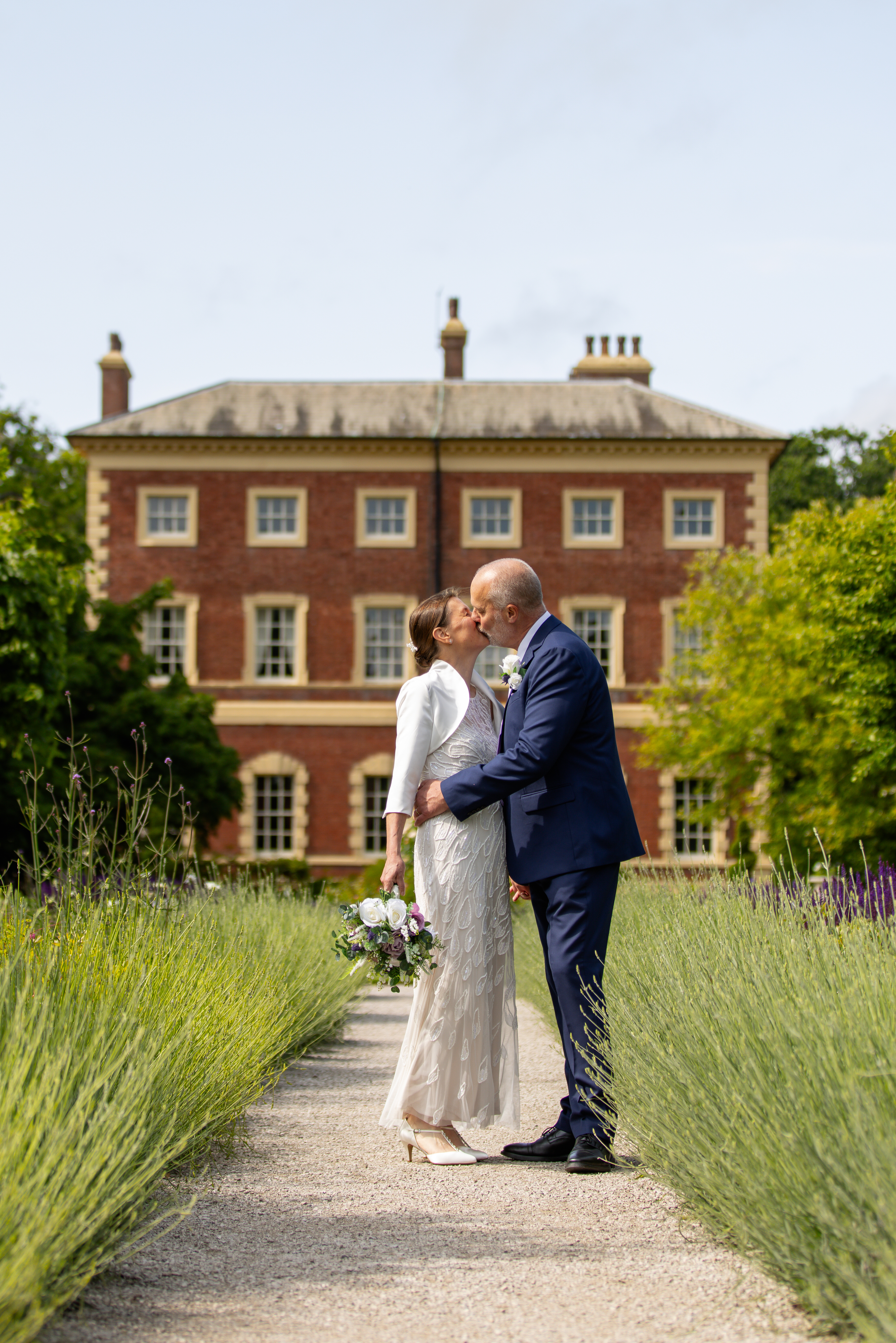The bride and groom walk in the grounds of Lytham Hall
