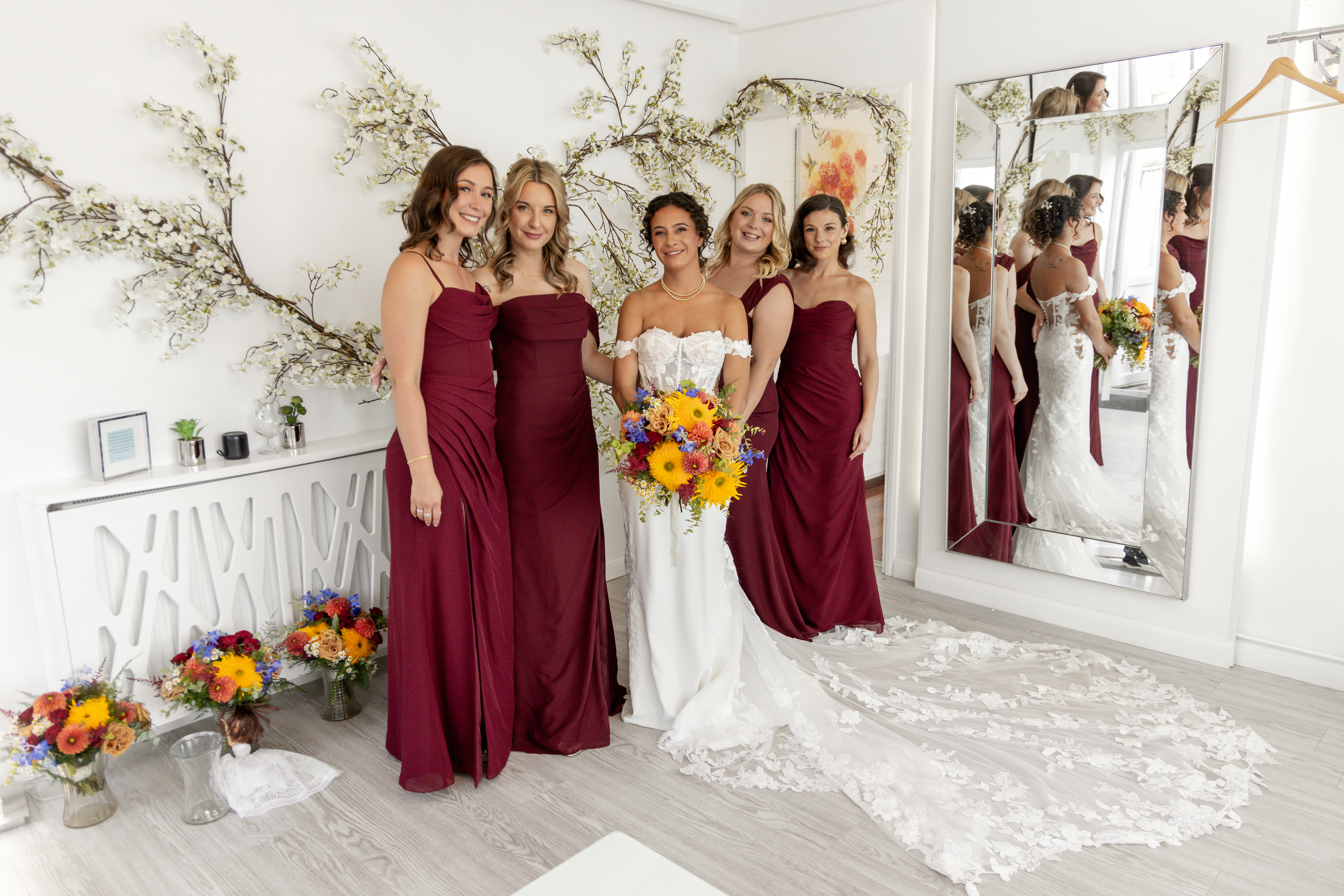 The bride and her bridesmaids all looking lovely in their wedding dresses 