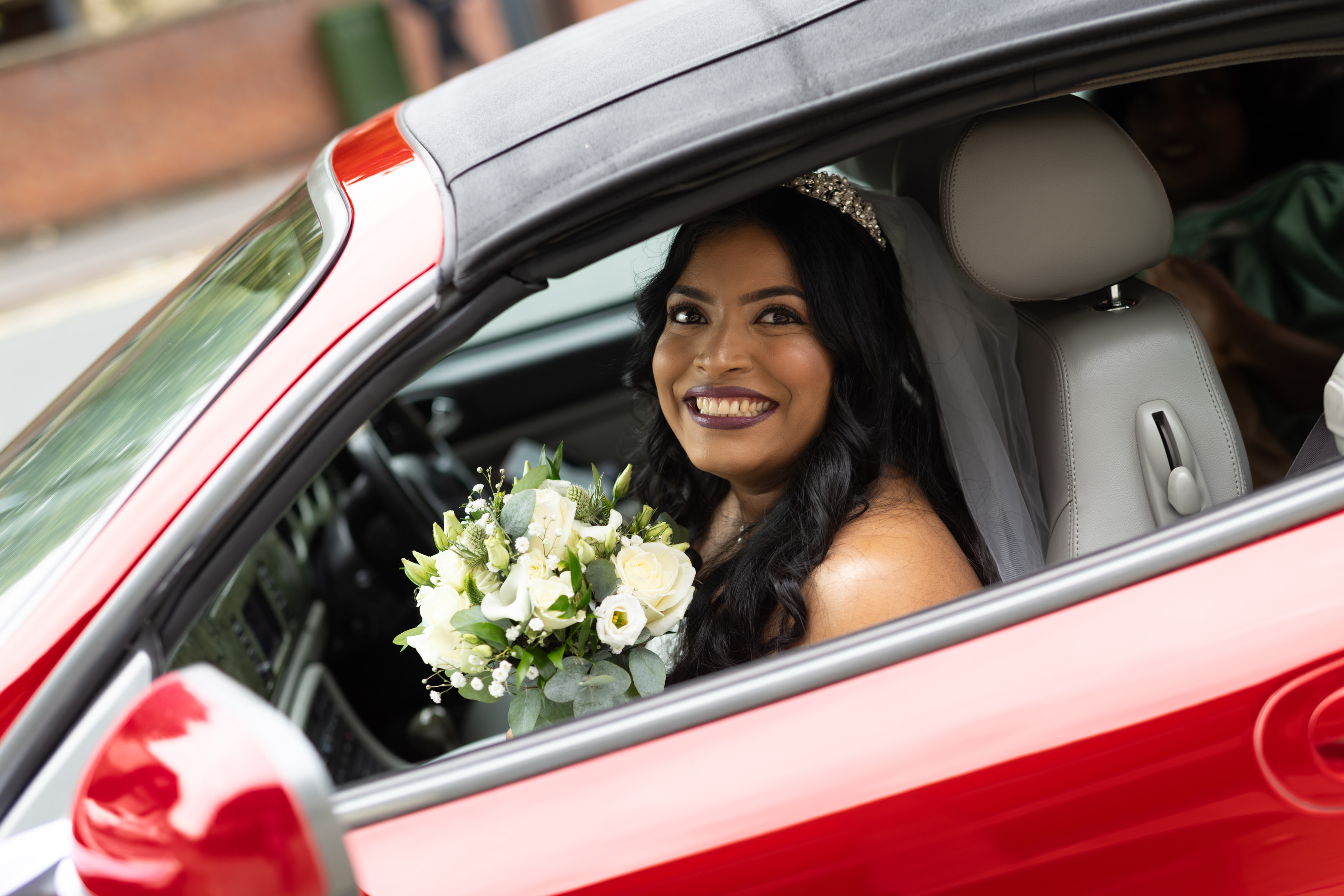 The Bride arriving in the red Ferrari 