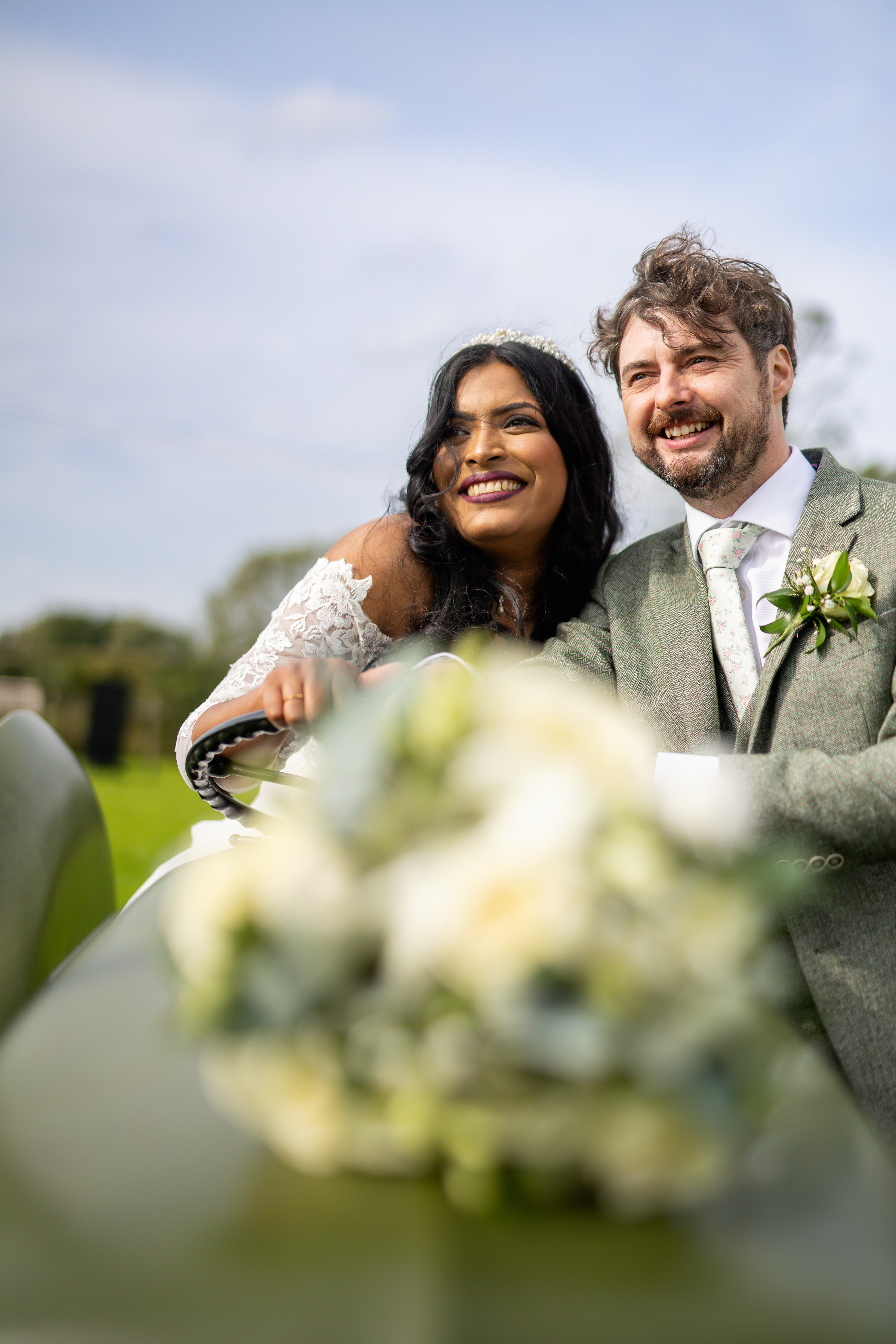 Tony and udara have some wedding photos on the tractor in the field at Haighton Manor