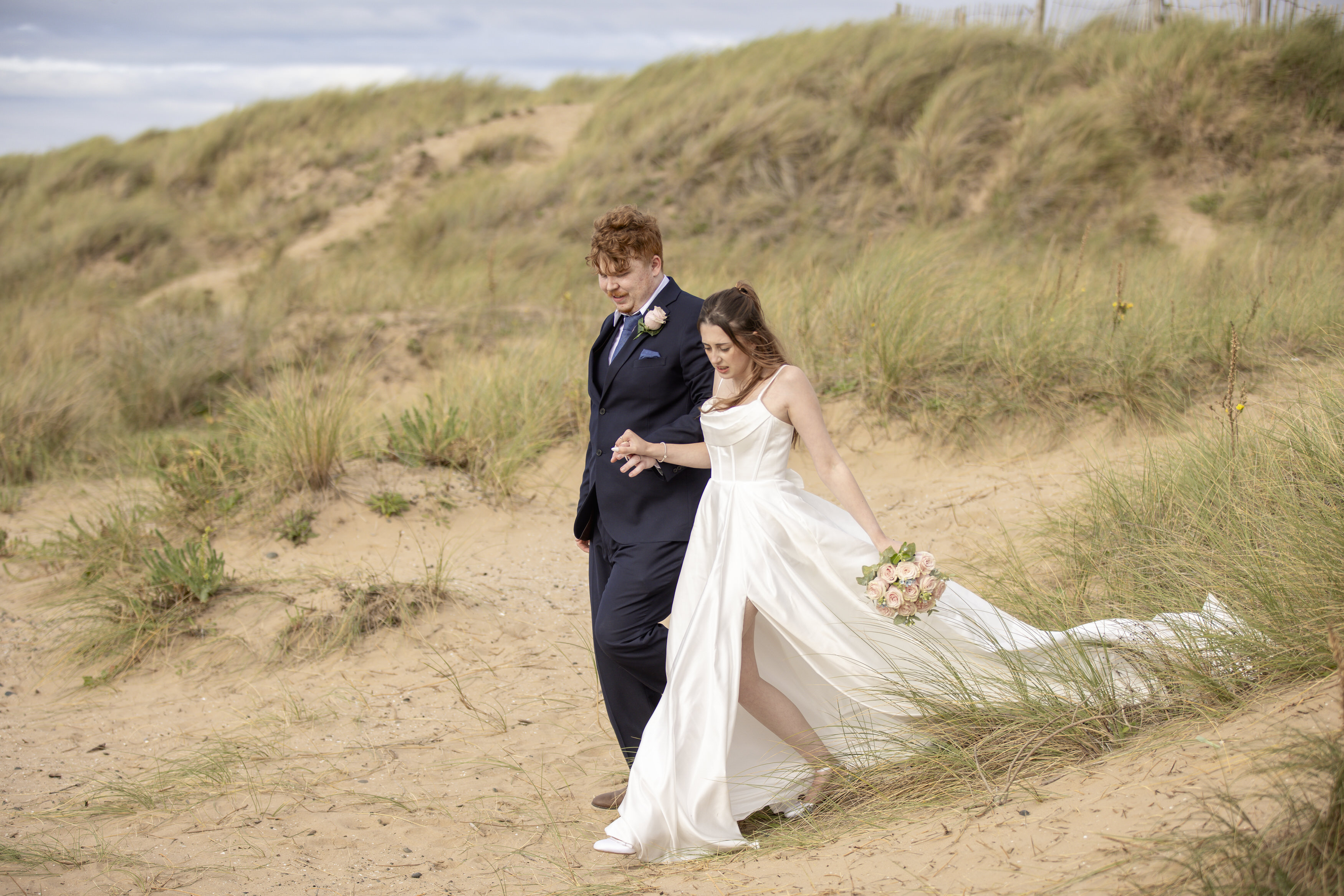 Ben and Katie walking down the sand dunes 
