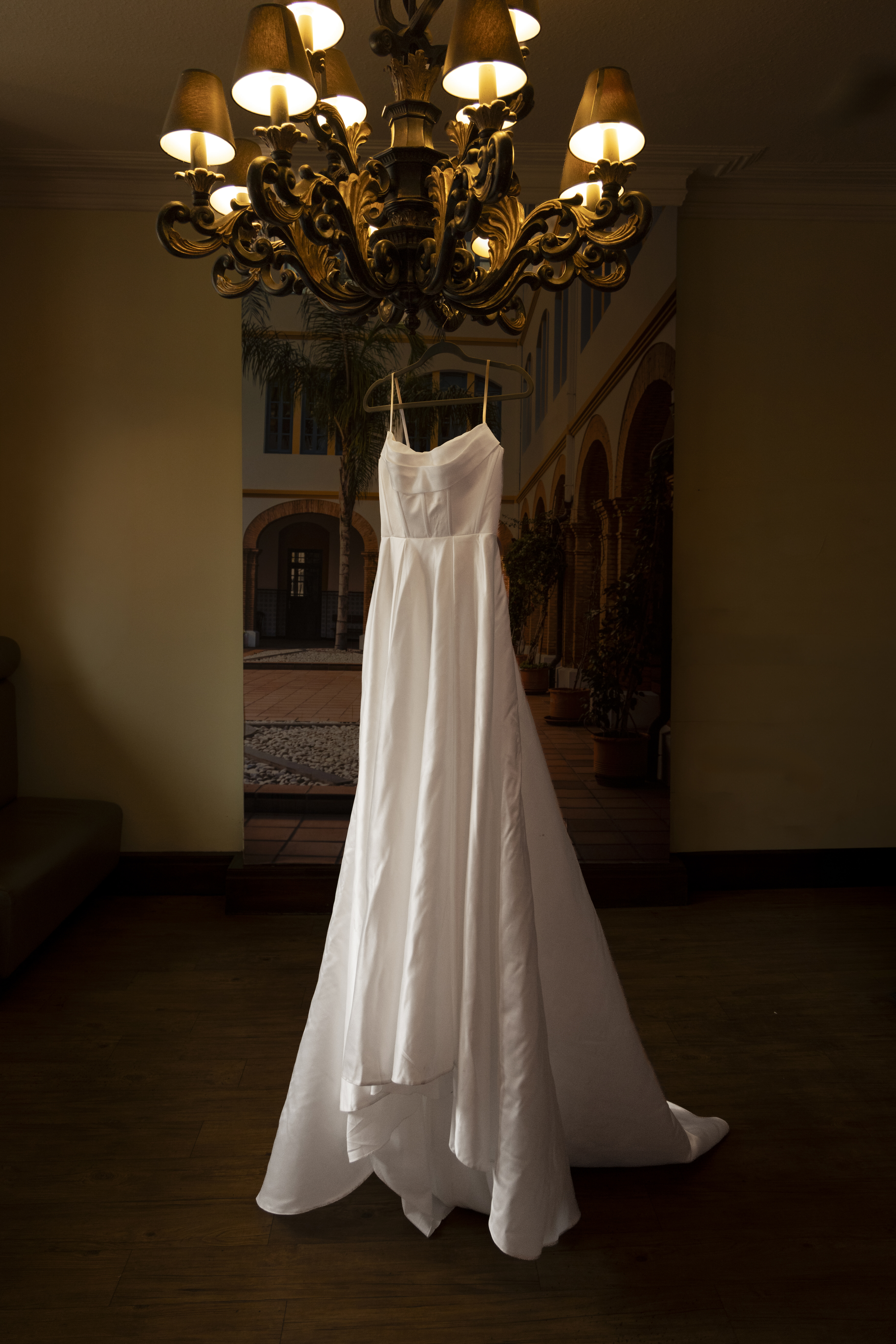 Katie's wedding dress hanging from the light 
