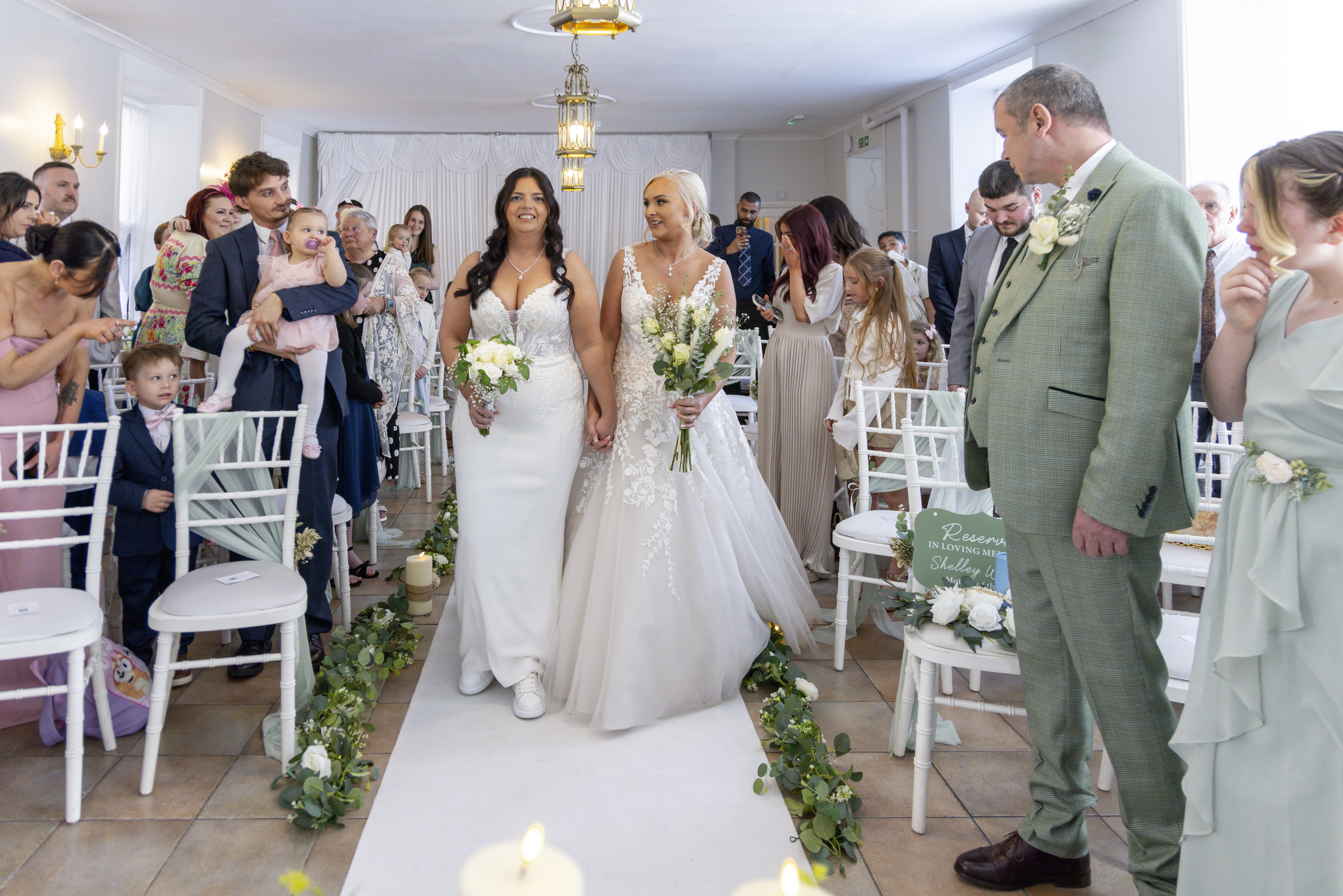 Sophie and Hollie make their way down ceremony room